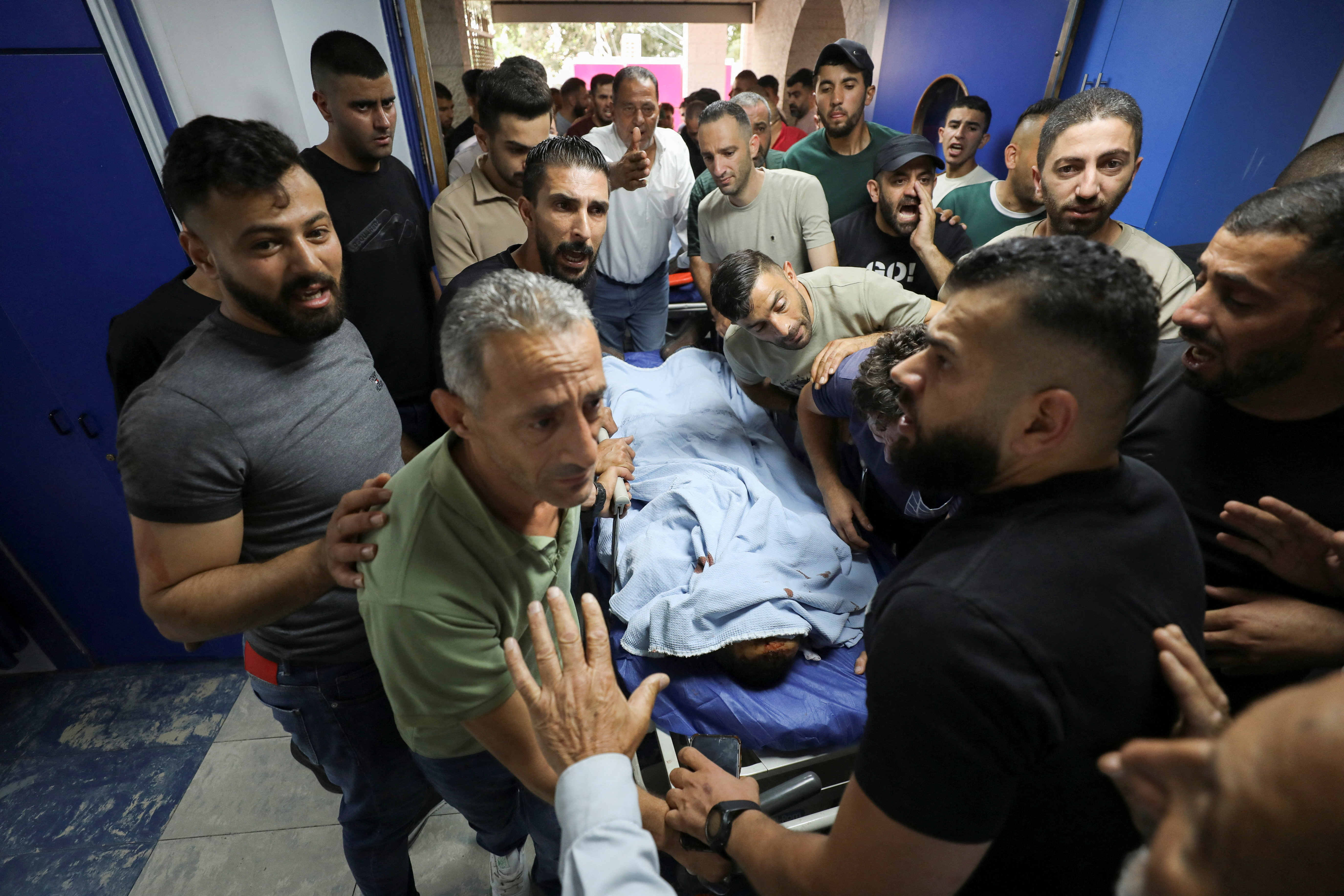 Palestinians gather around the body of a man who was killed during a confrontation with Israeli settlers, at a hospital in the Israeli-occupied West Bank city of Nablus, July 24, 2026. [Nidal Eshtayeh/Reuters]