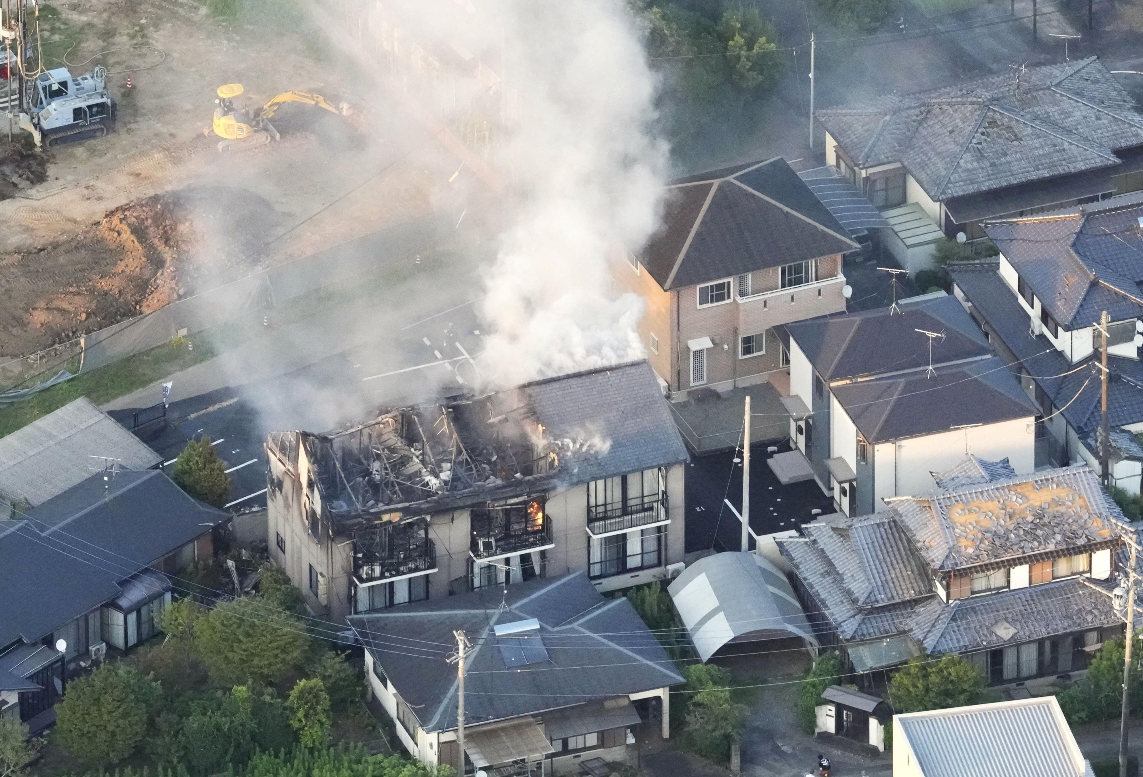 An aerial view shows a residential building on fire after an earthquake with a preliminary magnitude of 7.1 struck Japan's southern Kumamoto