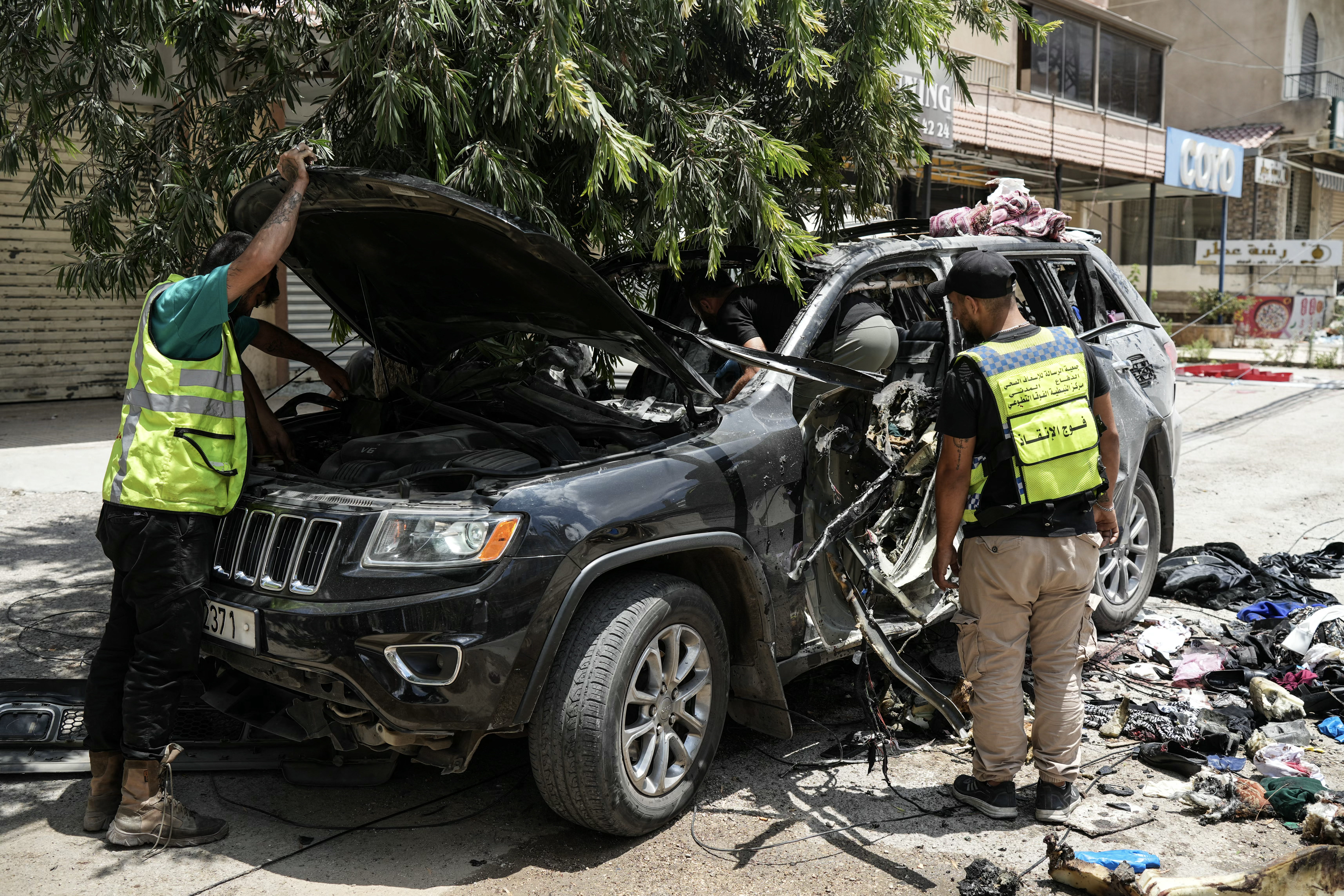 First responders inspect the wreckage of a car reportedly targeted by an Israeli strike in Nabatieh, Lebanon on July 6, 2026.