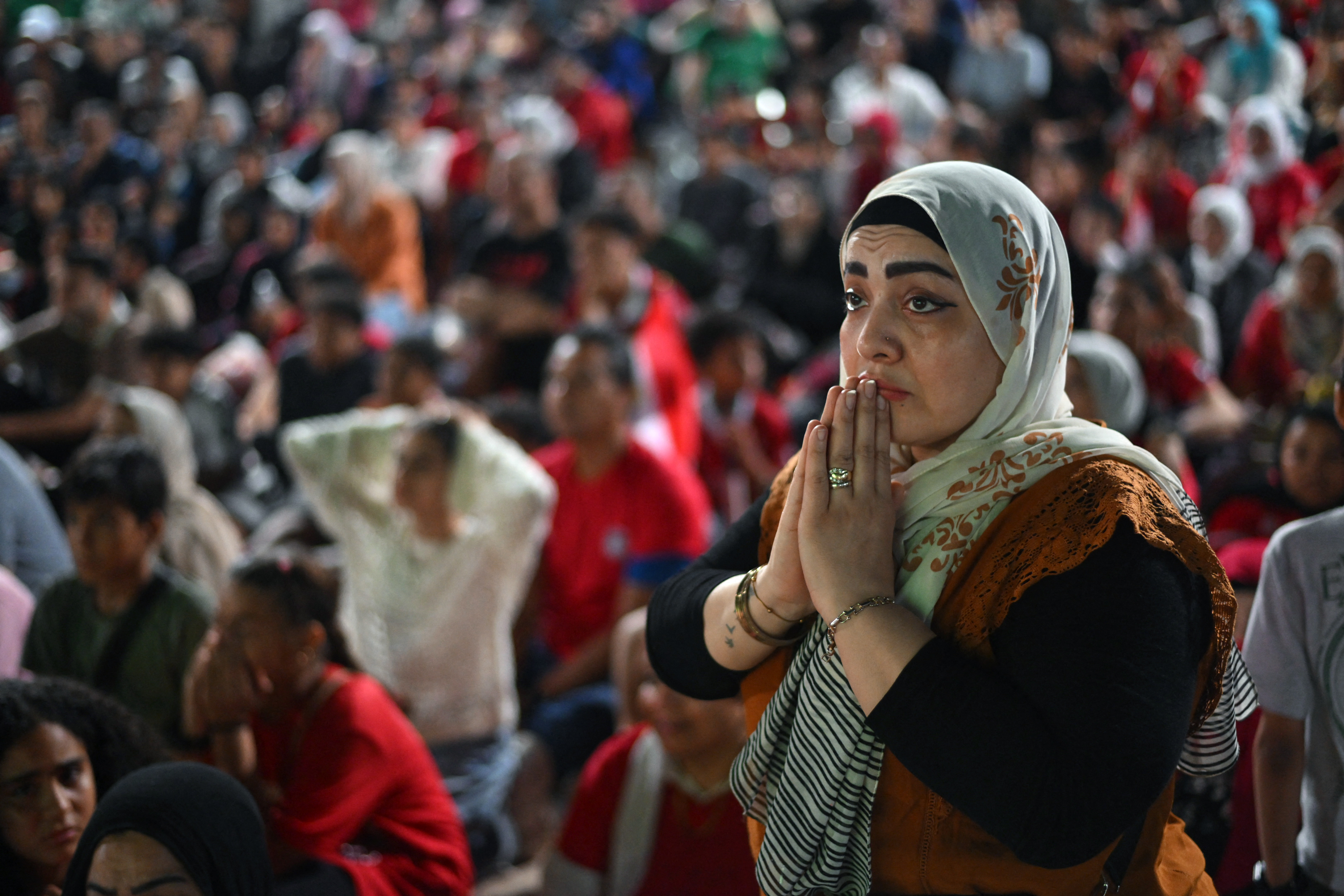 Egyptian football fans react at the end of their national team’s 2026 World Cup Round of 16 match against Argentina at a club park in Cairo’s Zamalek district on July 7, 2026. (Photo by Ahmed HASAN / AFP)