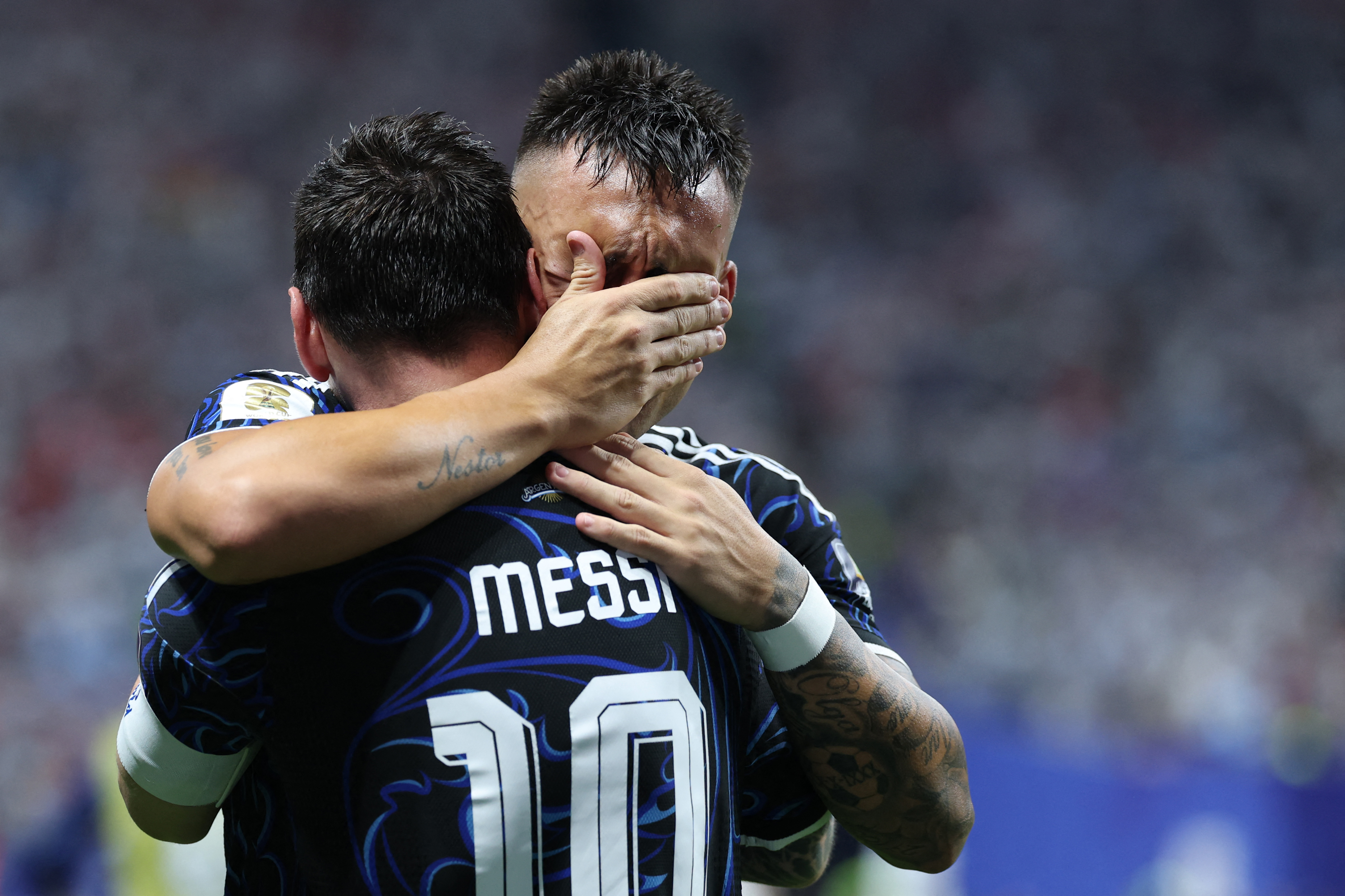 Argentina’s Lautaro Martinez celebrates with teammate Lionel Messi after scoring the match-winning goal against England in the second semifinal