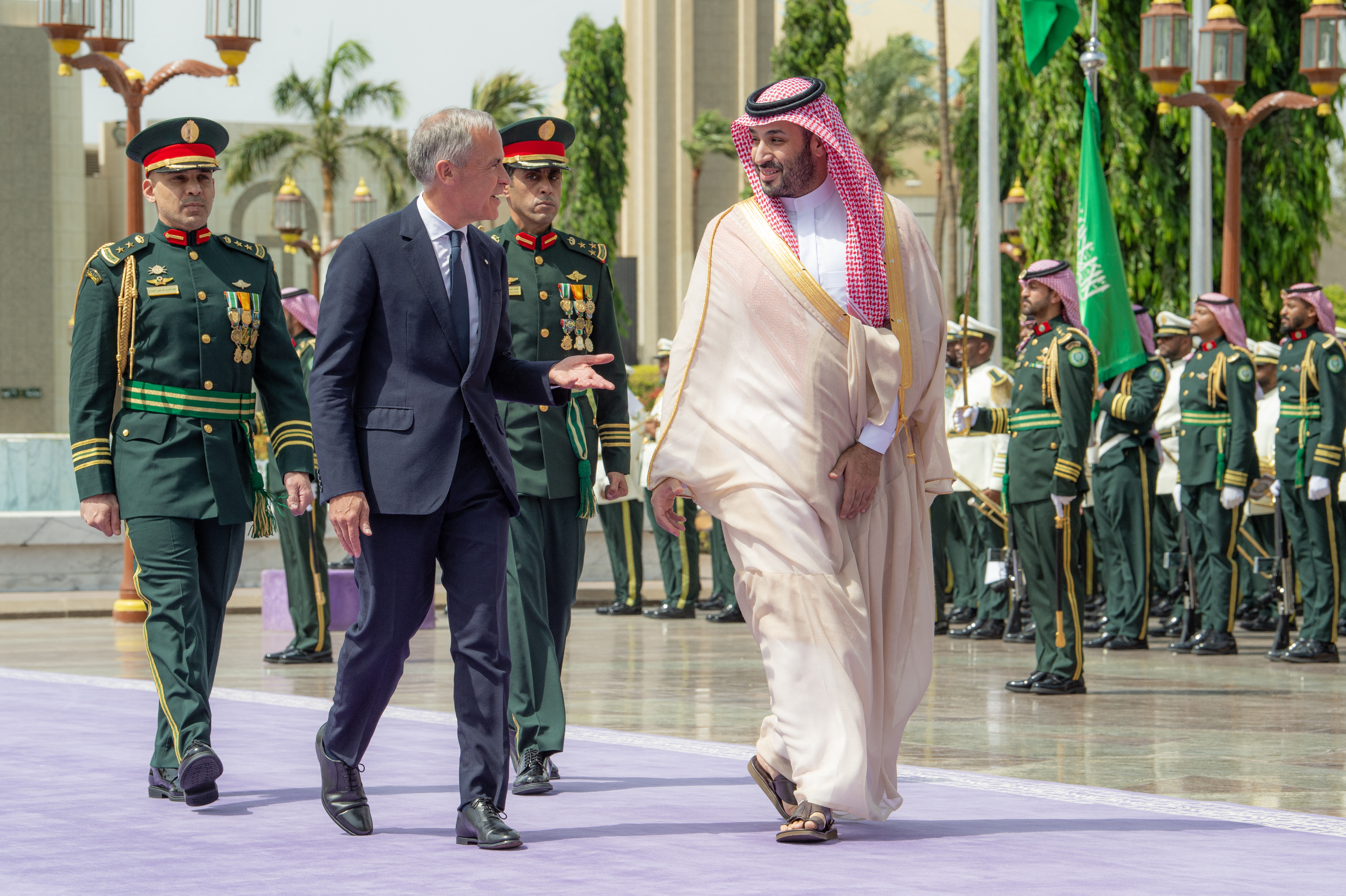 This handout picture released by the Saudi Ministry of Media shows Saudi Arabia's Crown Prince Mohammed bin Salman (R) walking with Canada's Prime Minister Mark Carney during his official visit at Al-Salam Royal Palace in Jeddah on July 9, 2026. (Photo by Saudi Ministry of Media / AFP) / RESTRICTED TO EDITORIAL USE - MANDATORY CREDIT "AFP PHOTO / SAUDI MINISTRY OF MEDIA / HANDOUT / " - NO MARKETING NO ADVERTISING CAMPAIGNS - DISTRIBUTED AS A SERVICE TO CLIENTS