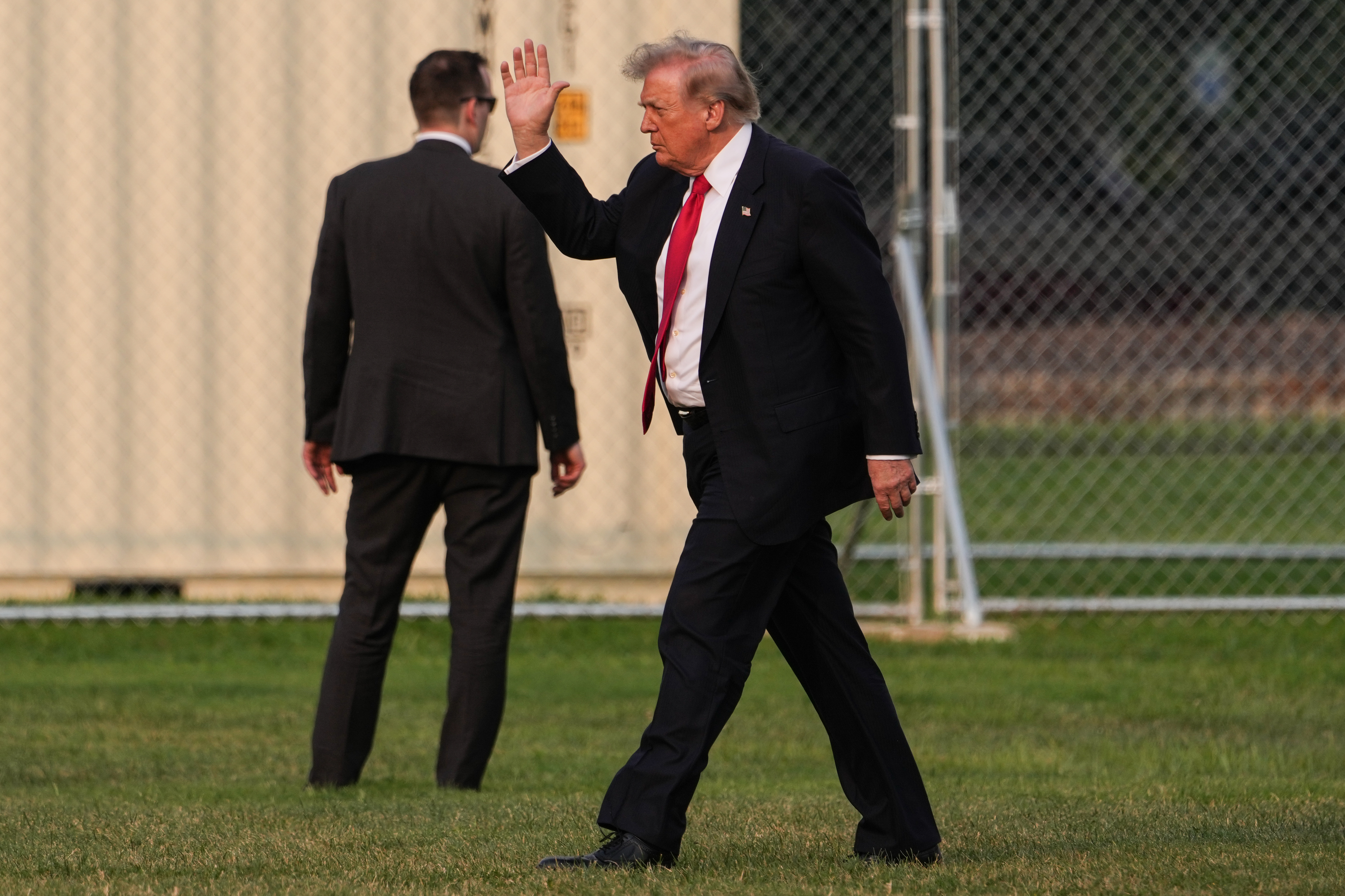 President Donald Trump waves while walking on the Ellipse after arriving on Marine One, Monday, July 27, 2026, near the White House in Washington. (AP Photo/Julia Demaree Nikhinson)