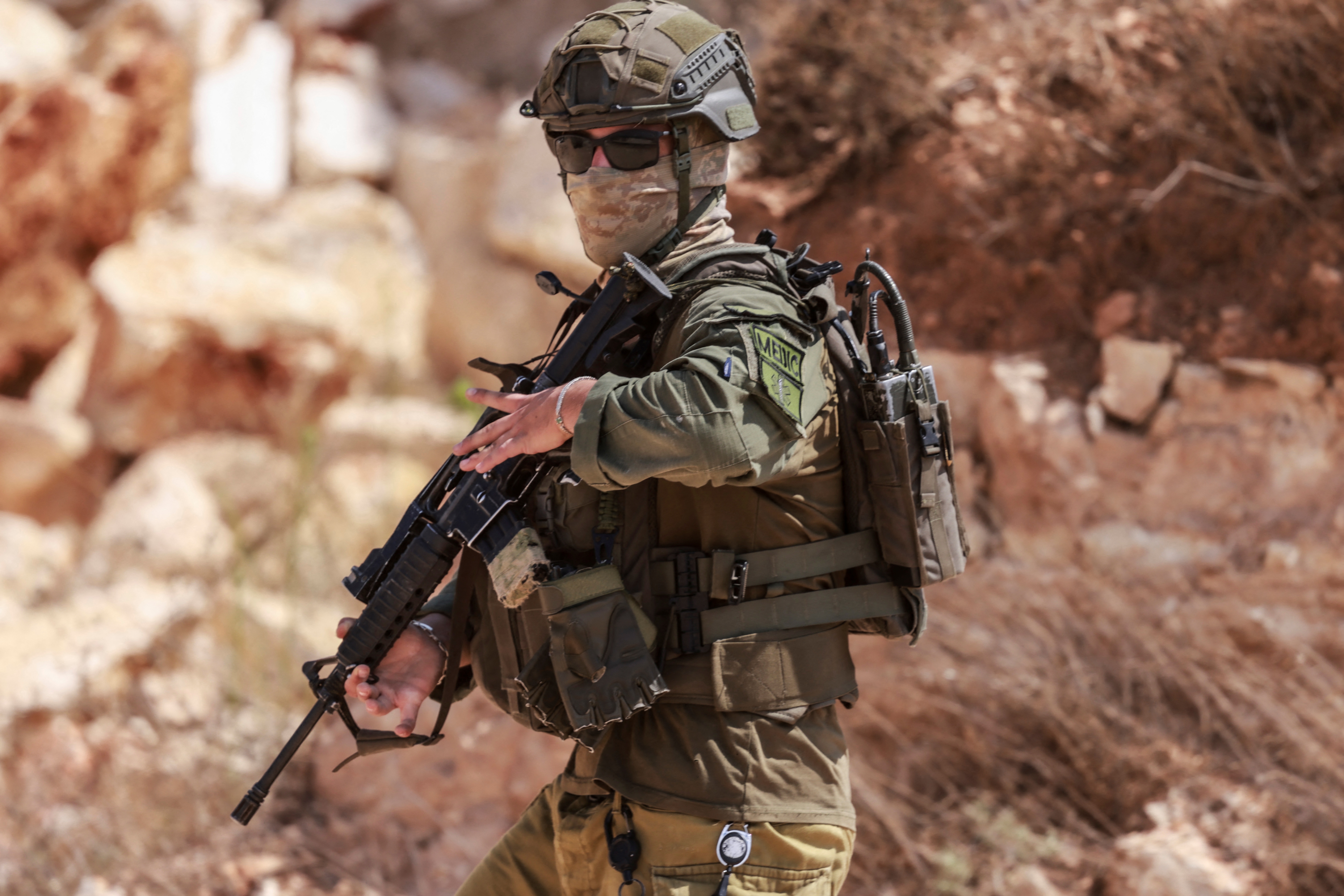 An Israel soldier secures the area as the military arrives in the village of Qusra, south of the city of Nablus in the Israeli-occupied West Bank, which has faced escalating Israeli settler violence over the past month, on 29 August 2026. Dozens of Israeli settlers attacked the Palestinian village of Qusra in the northern occupied West Bank on August 29, residents and the military said, after nearly three weeks of tension in the area. Earlier in August, a group of settlers began blocking supplies from entering Palestinian houses on the outskirts of the village near Nablus, trapping residents inside and drawing domestic and international condemnation. (Photo by Jaafar ASHTIYEH / AFP)
