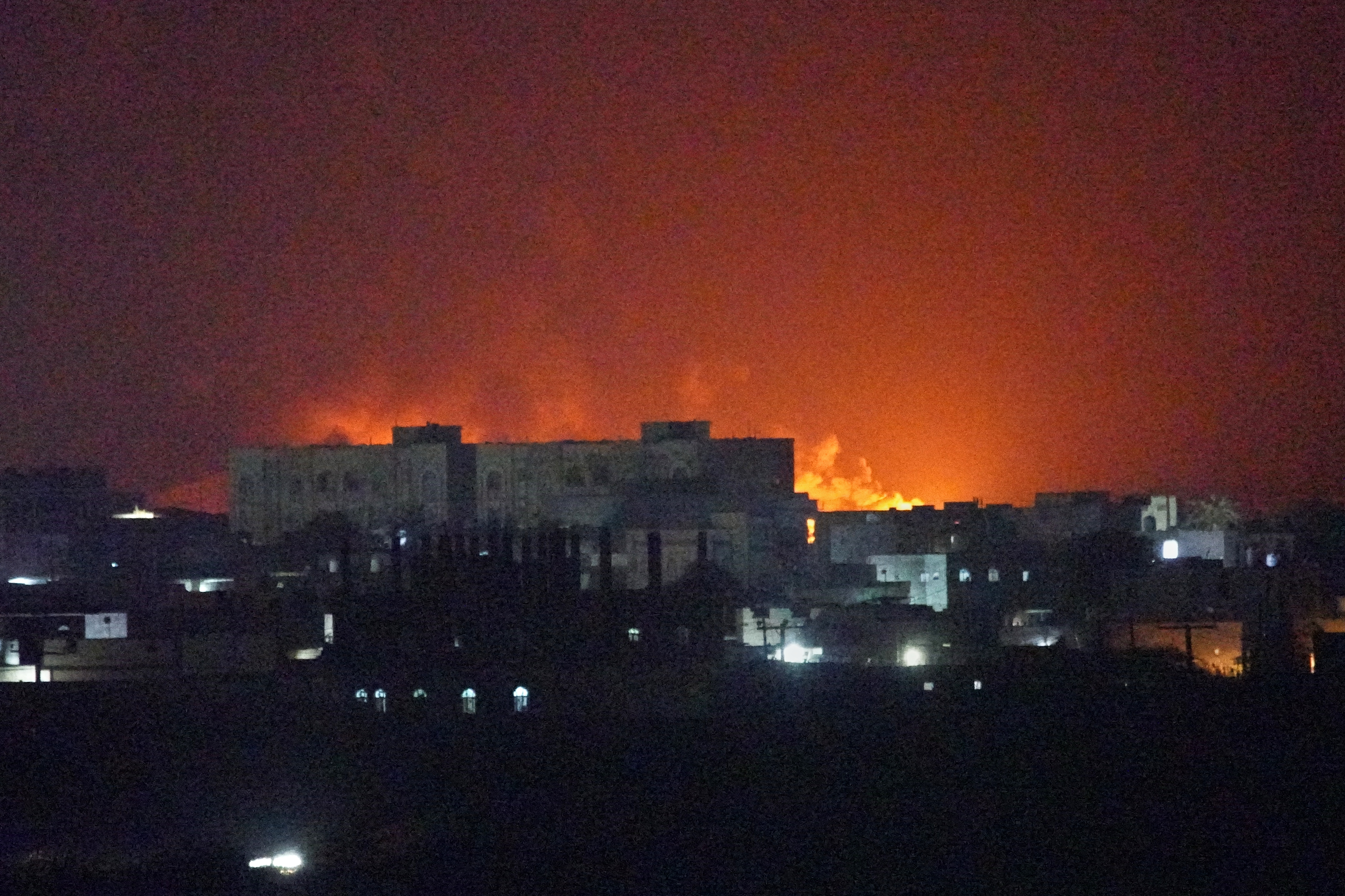 Flames and smoke rise from the port of al-Makha during a strike in Yemen