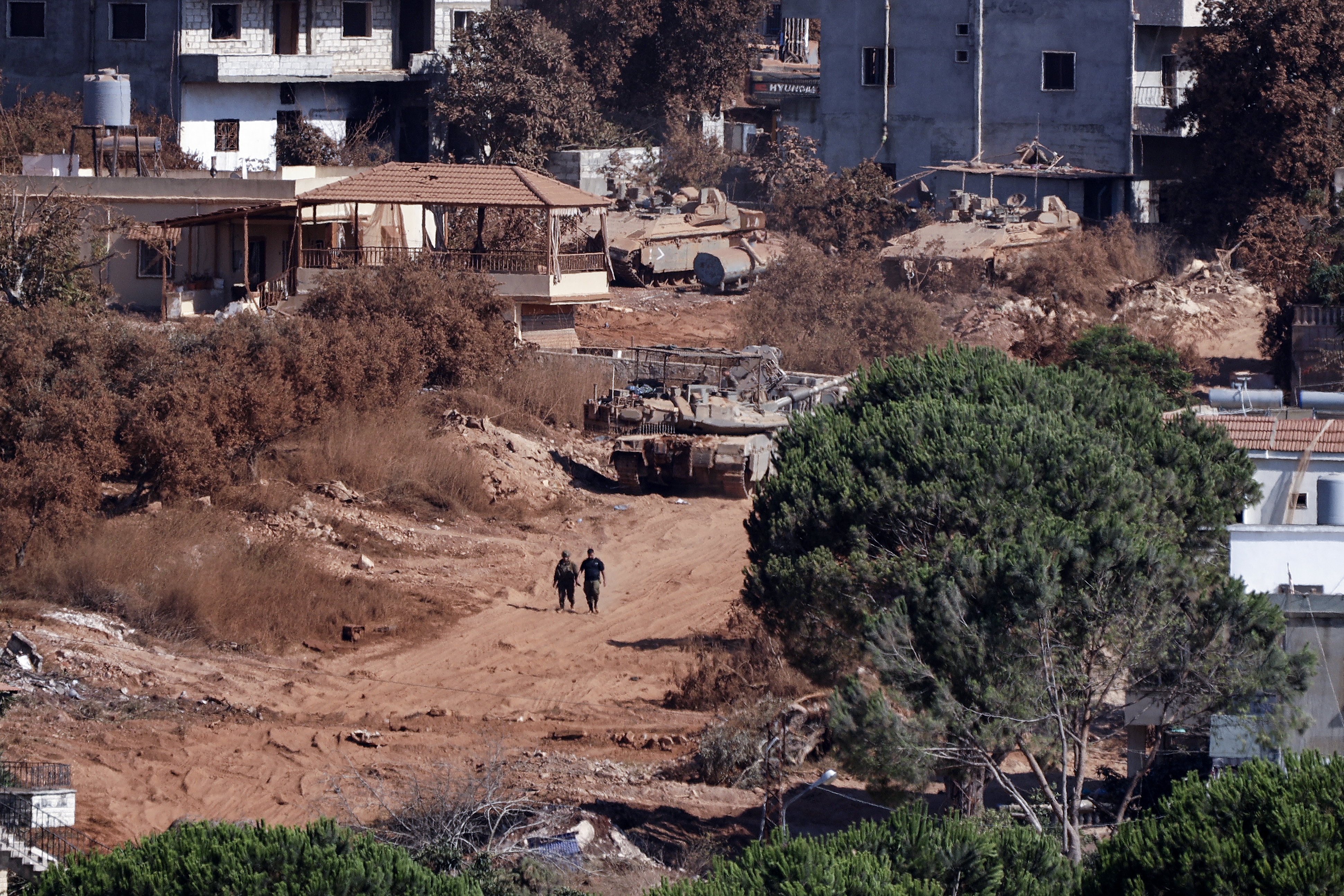 A photograph taken from the southern Lebanese viallage of of Zawtar al-Gharbiyah shows Israeli troops stationed in the nearby village of Zawtar al-Charkiyah on August 11, 2026.