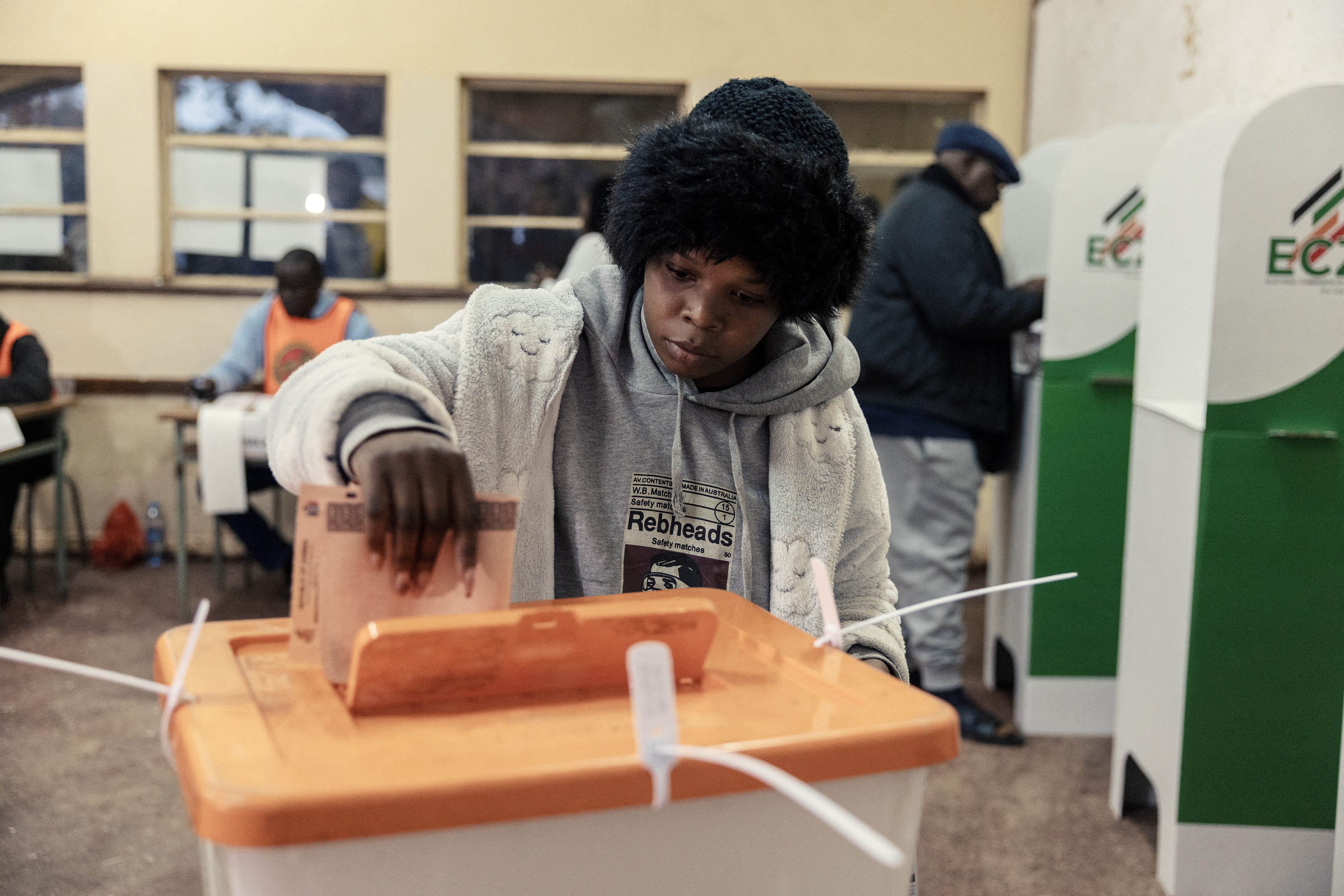 TOPSHOT - A woman casts her ballot at a polling station in Lusaka on August 13, 2026.