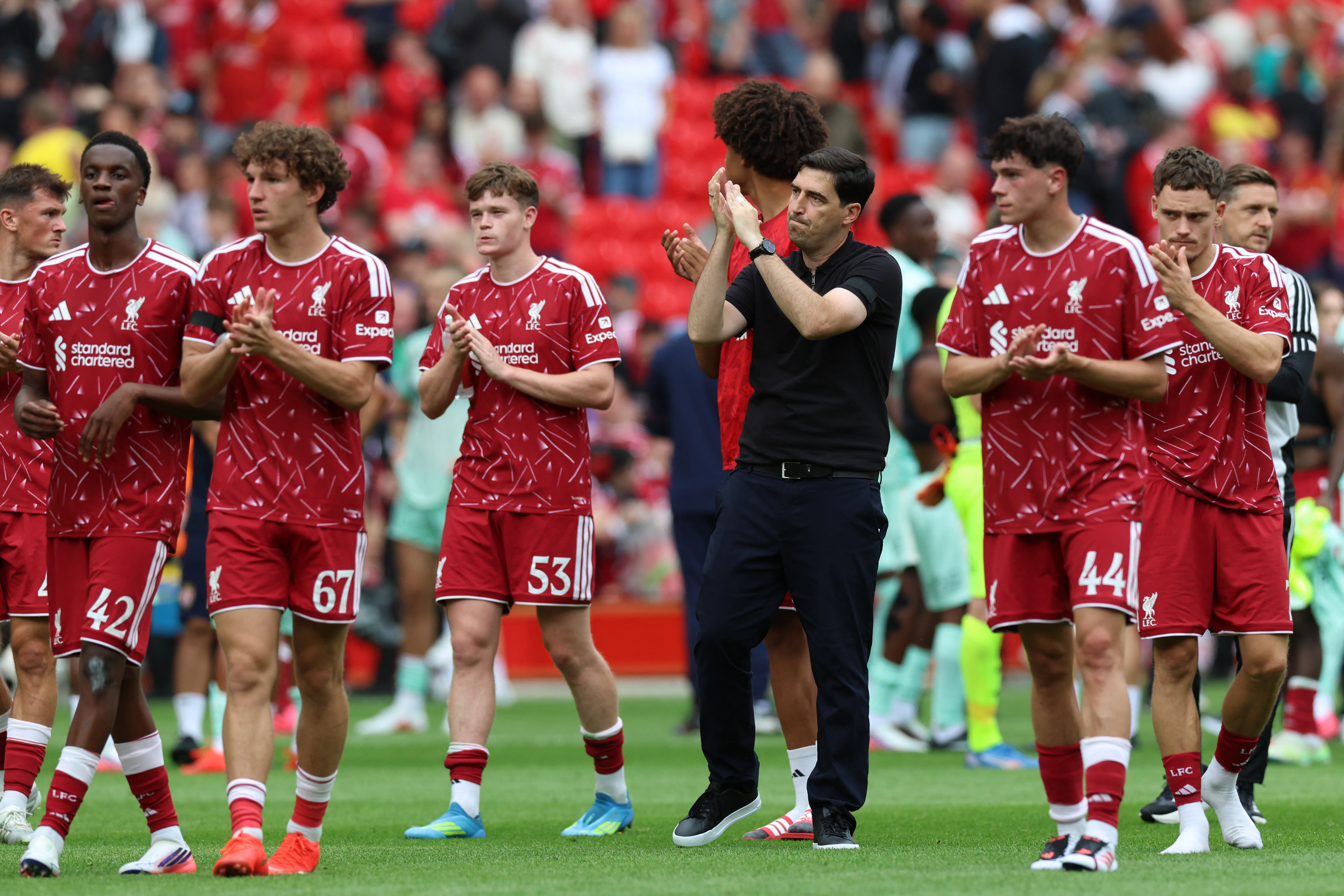 Liverpool's Spanish head coach Andoni Iraola (C) and players applaud fans after the pre-season friendly football match between Liverpool and Monaco at Anfield in Liverpool, north west England on August 9, 2026.