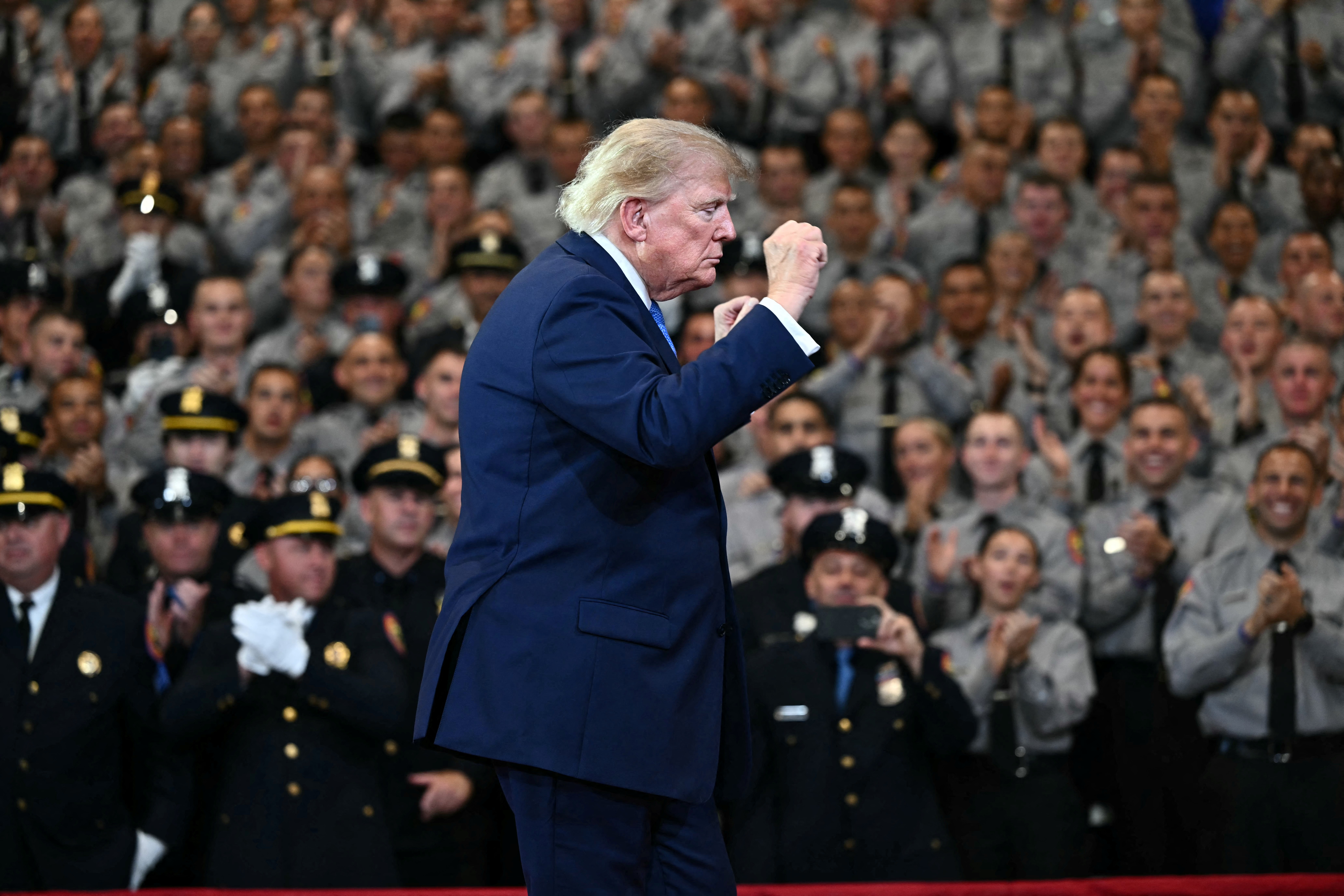 US President Donald Trump gestures as he departs after delivering remarks at the Nassau County Police Academy Center for Training and Intelligence in Garden City, New York, on August 14, 2026. (Photo by Kent NISHIMURA / AFP)
