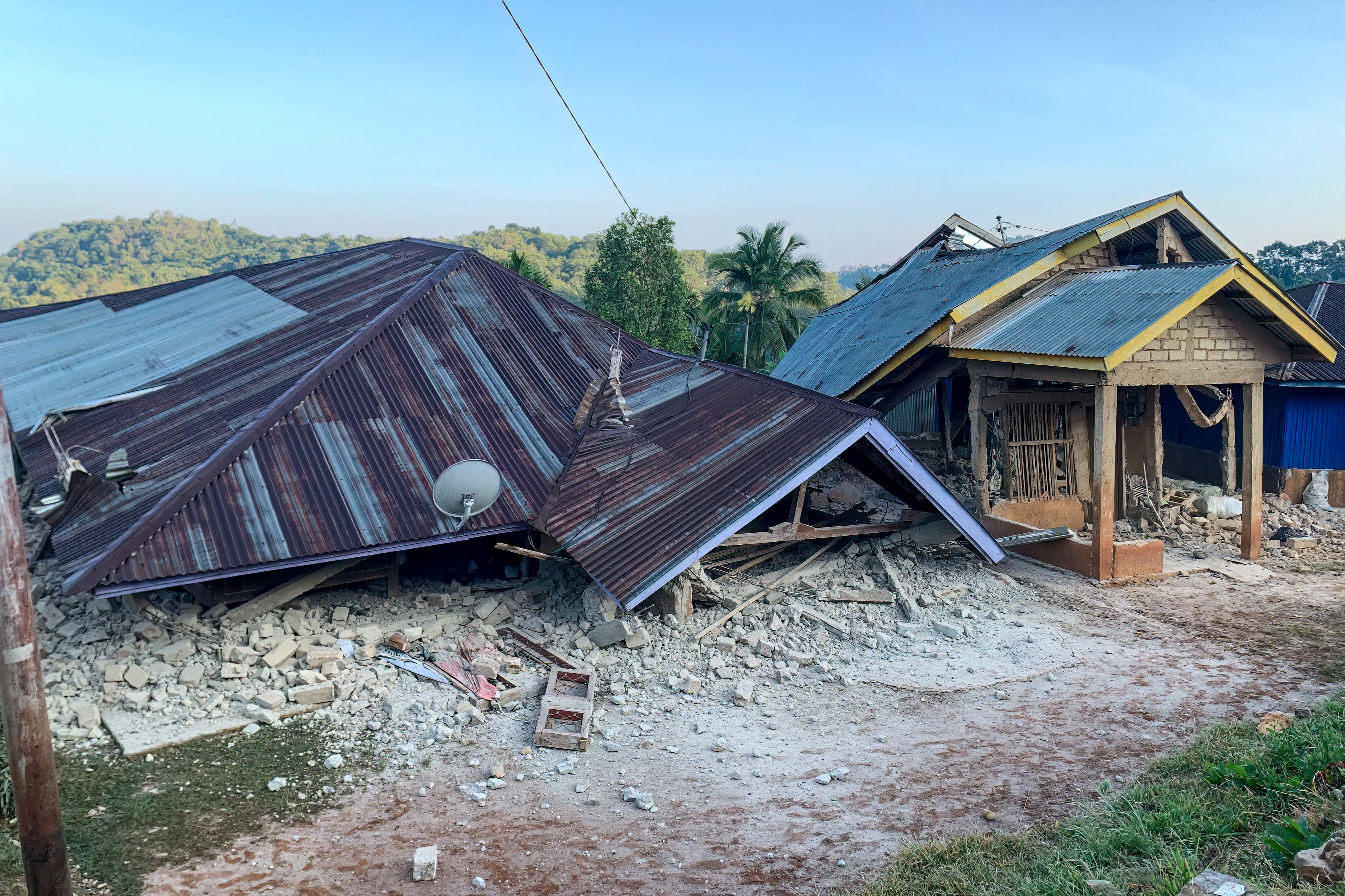 TOPSHOT - Damaged houses are seen following a 7.7-magnitude earthquake in Ruteng, Manggarai, East Nusa Tenggara, on August 15, 2026.