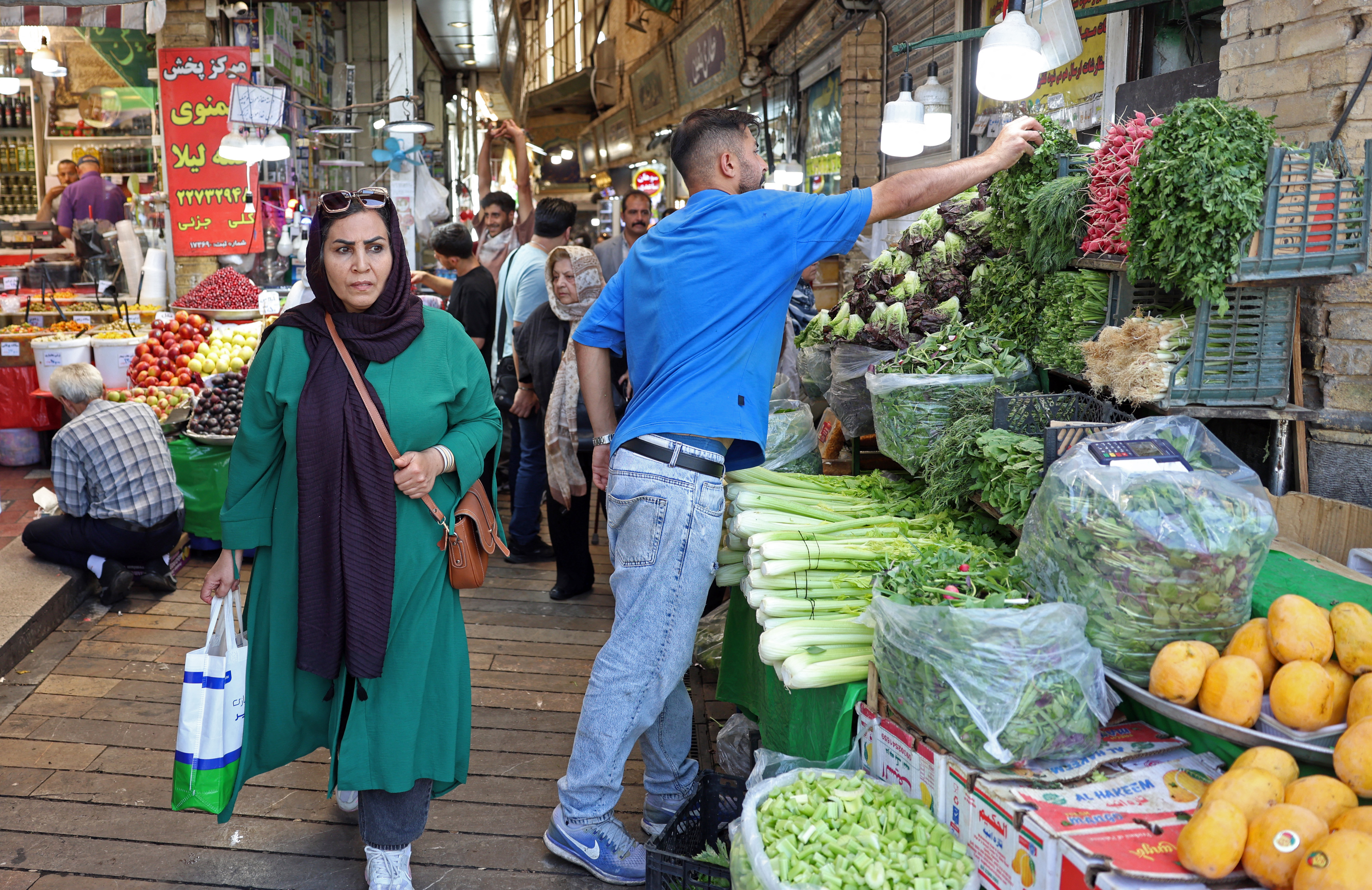 People shop for produce at the historic Tajrish bazaar.