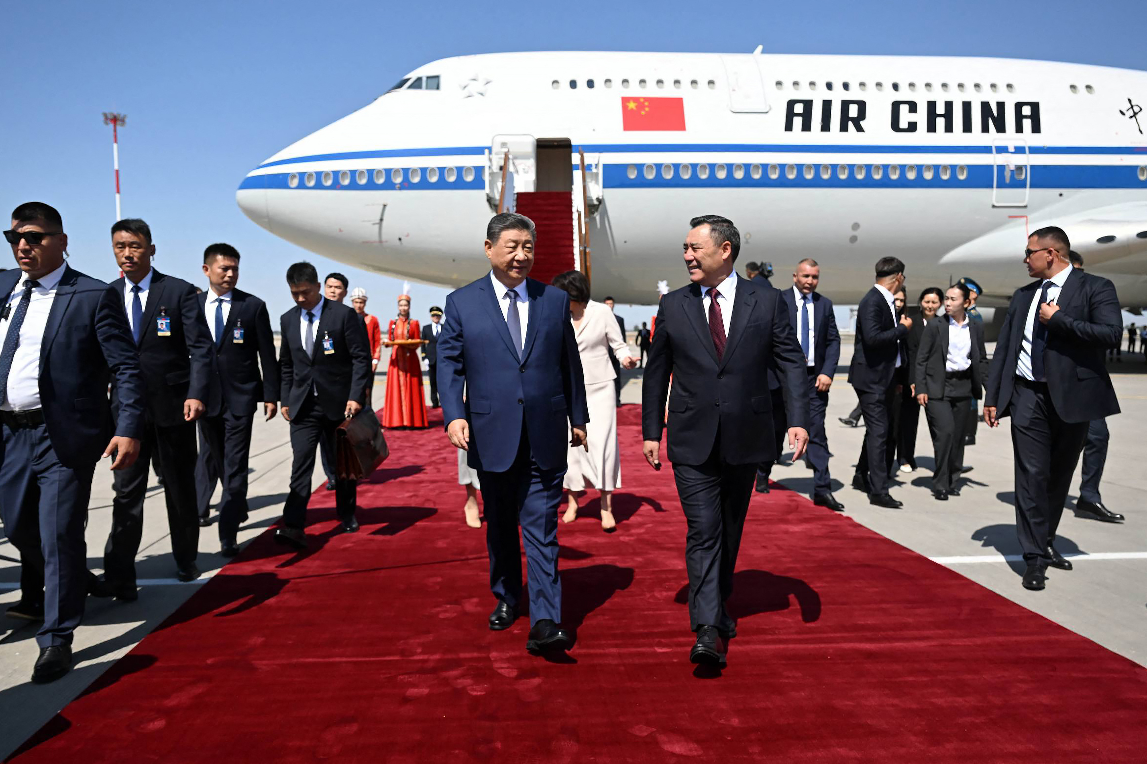 Kyrgyzstan's President Sadyr Japarov, centre-right, welcomes China’s President Xi Jinping, centre-left, upon his arrival in Bishkek, ahead of the Shanghai Cooperation Organisation summit. [AFP]