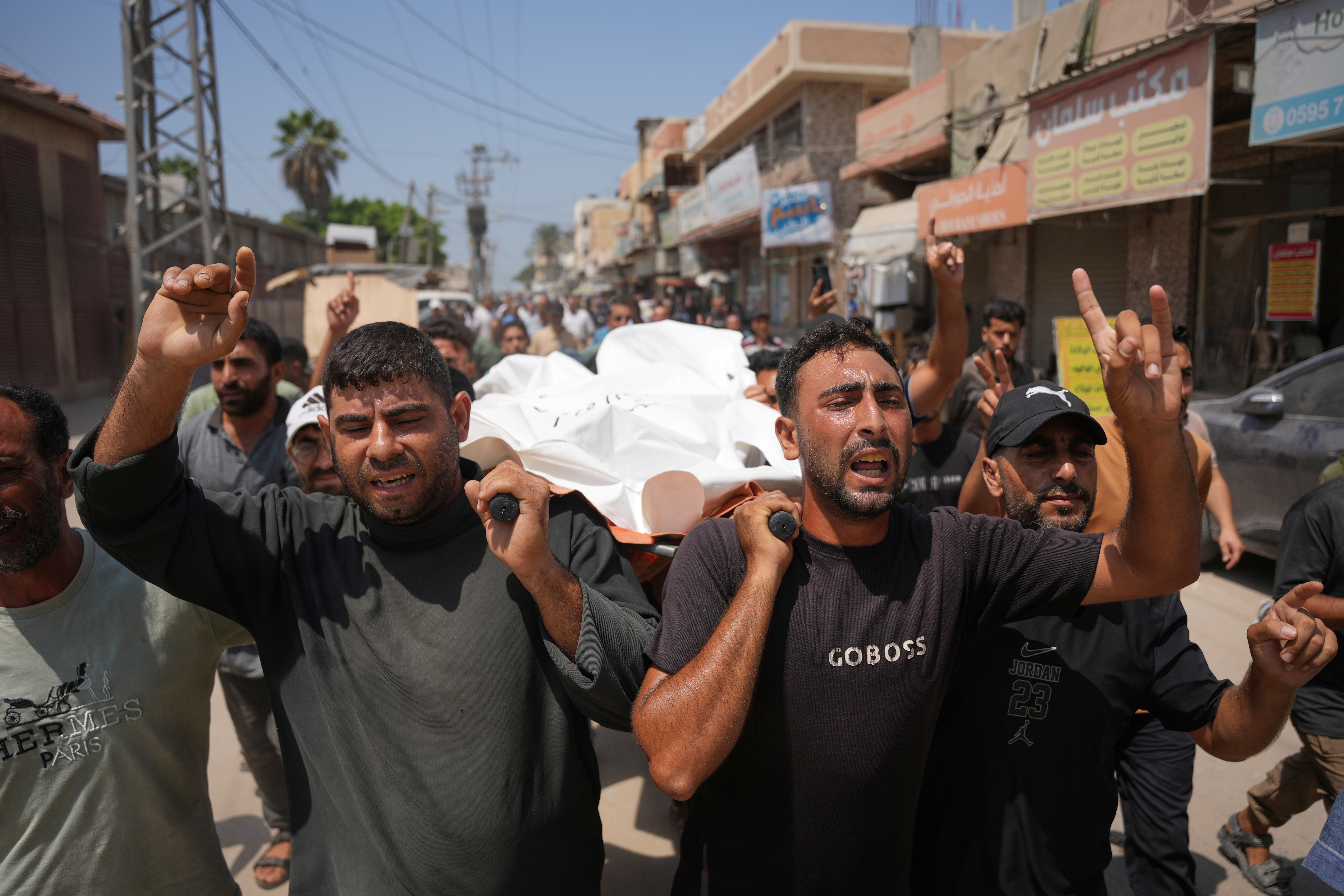 Palestinian mourners carry the body of Hamouda al-Attar, who was killed by the Israeli army, during his funeral at al-Aqsa Hospital in Deir al-Balah, central Gaza Strip, Saturday, Aug. 29, 2026. (AP Photo/Abdel Kareem Hana)