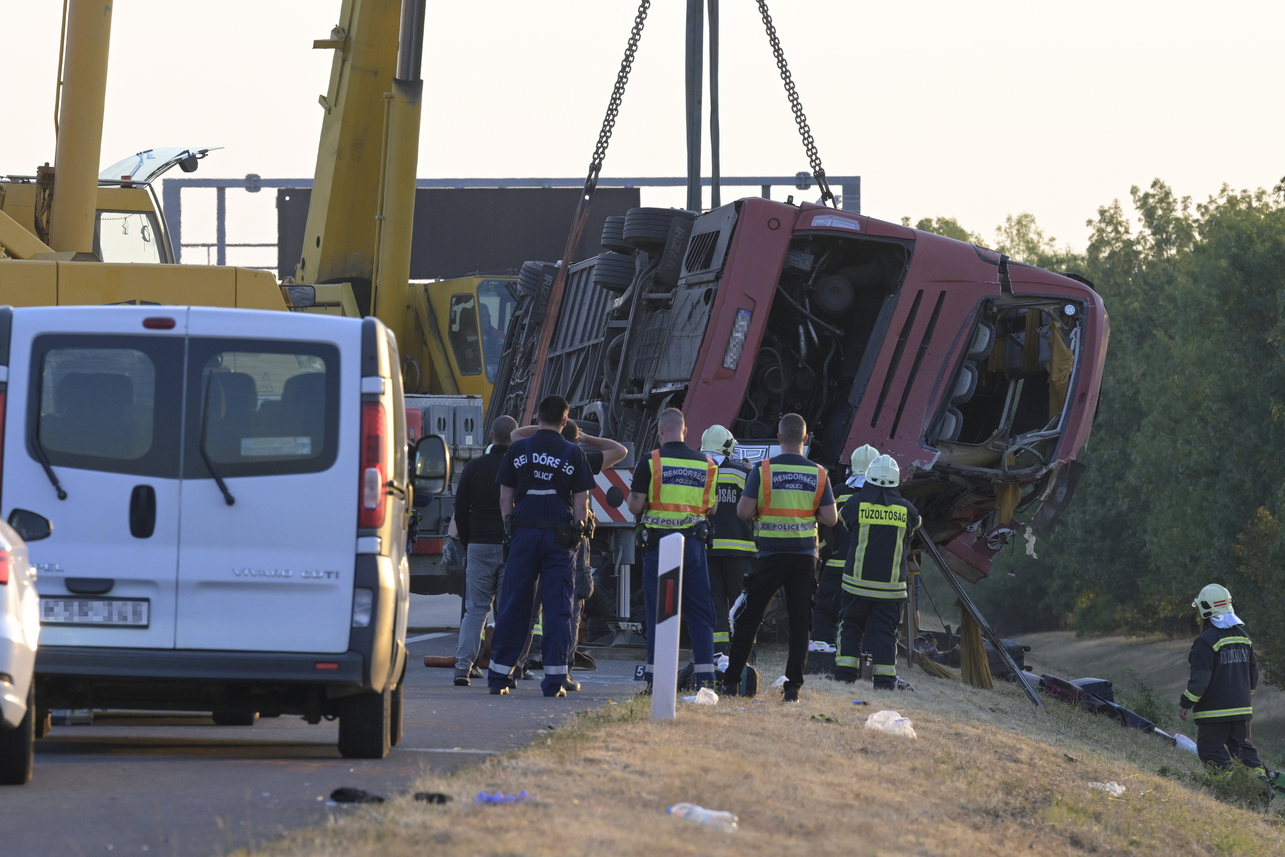 epa13173211 Emergency services attend the scene after a tourist bus travelling from Poland went off the road and overturned in a ditch along the M3 motorway between Mezokeresztes and Mezonagymihaly, Hungary, 16 August 2026. A dozen people were killed and others were seriously injured. EPA/ZOLTAN MATHE HUNGARY OUT