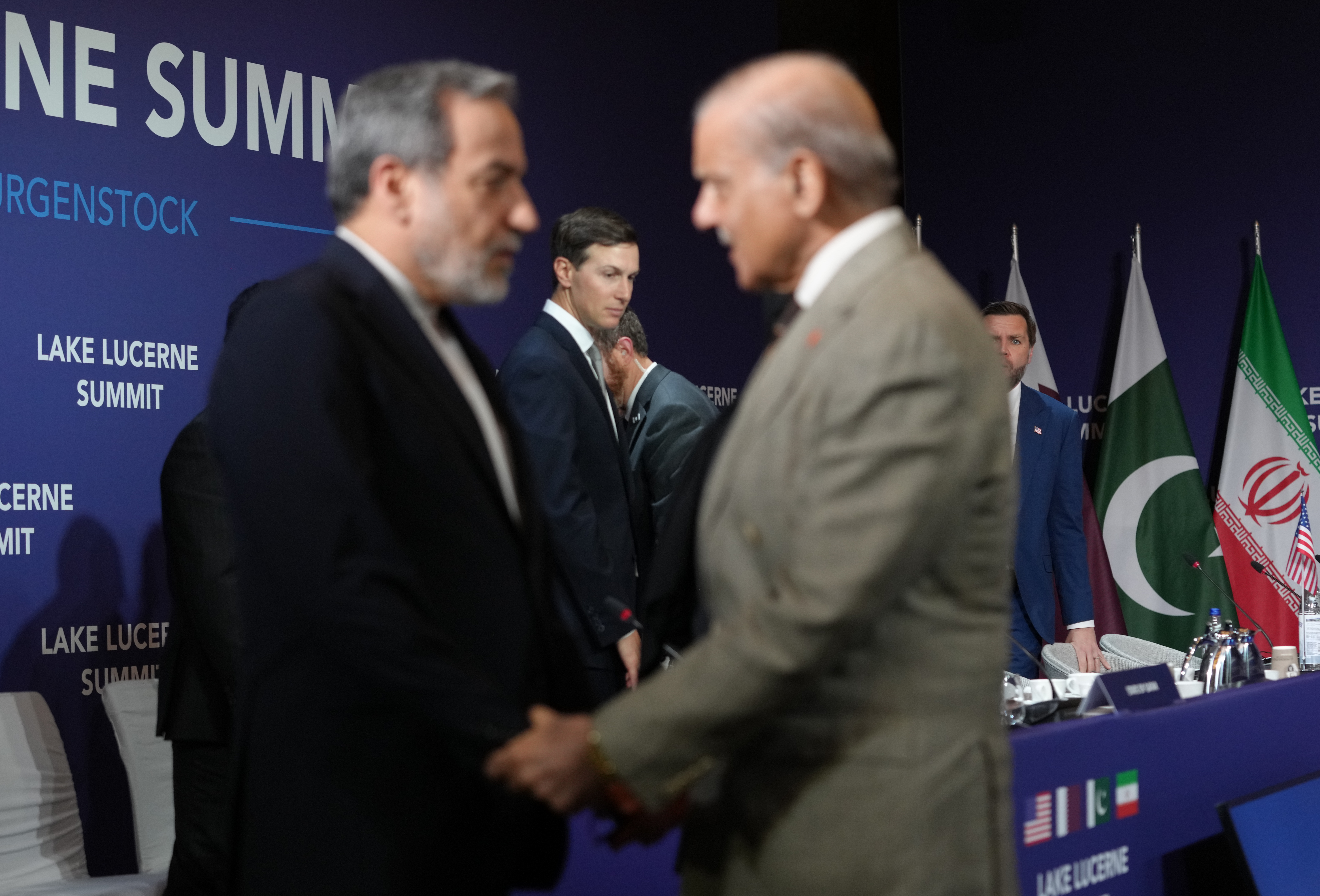 STANSSTAD, SWITZERLAND - JUNE 21: U.S. Vice President JD Vance (R) looks on next to U.S. President Donald Trump's son-in-law Jared Kushner, as Iran's Foreign Minister Abbas Araqchi (L) shakes hands with Pakistan's Prime Minister Shehbaz Sharif, before the start of a quadrilateral meeting between the U.S., Iran, Pakistan, and Qatar at the Lake Lucerne Summit, aimed at advancing a deal to end the Middle East conflict at the Buergenstock Resort, Lake Lucerne on June 21, 2026 near Stansstad, Switzerland. Vance is visiting Switzerland for negotiations with Iran to end the war and open the Strait of Hormuz that have been delayed by Israeli strikes in Lebanon. (Photo by Nathan Howard-Pool/Getty Images)