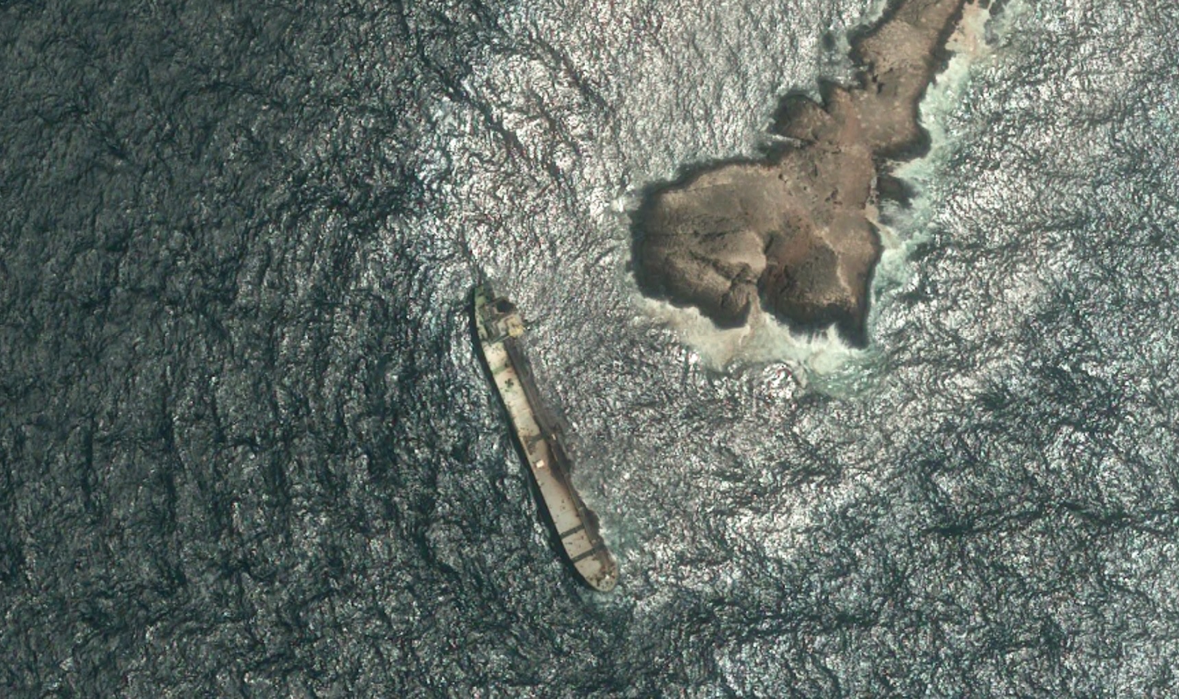 Aerial view of ship near land.