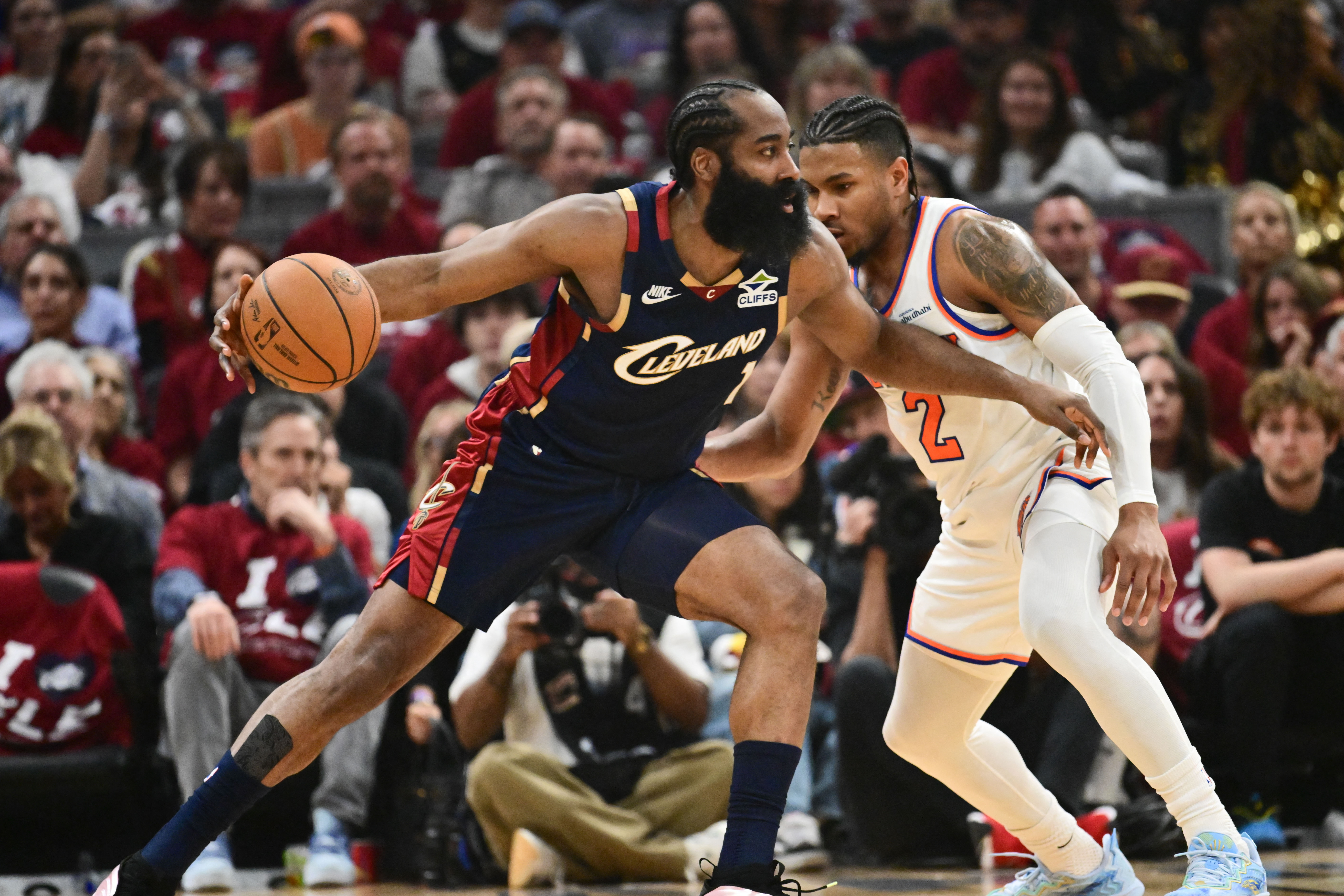 May 25, 2026; Cleveland, Ohio, USA; Cleveland Cavaliers guard James Harden (1) moves the ball while defended by New York Knicks guard Miles McBride (2) in the second quarter during game four of the eastern conference finals for the 2026 NBA playoffs at Rocket Arena. Mandatory Credit: Ken Blaze-Imagn Images