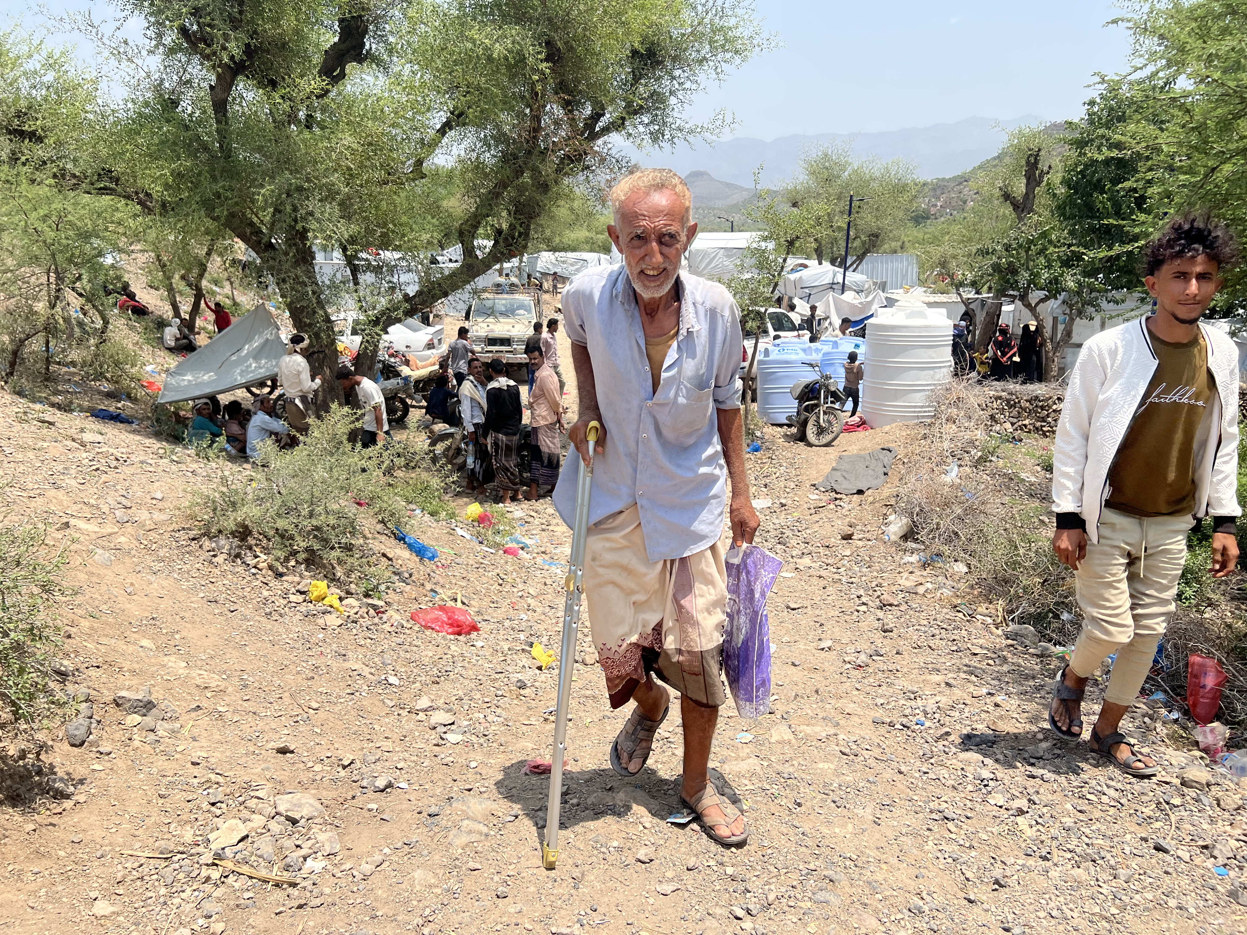 An elderly displaced person on the outskirts of the Al-Ghazaliyah camp for displaced persons in the Al-Birin area [Al Jazeera]