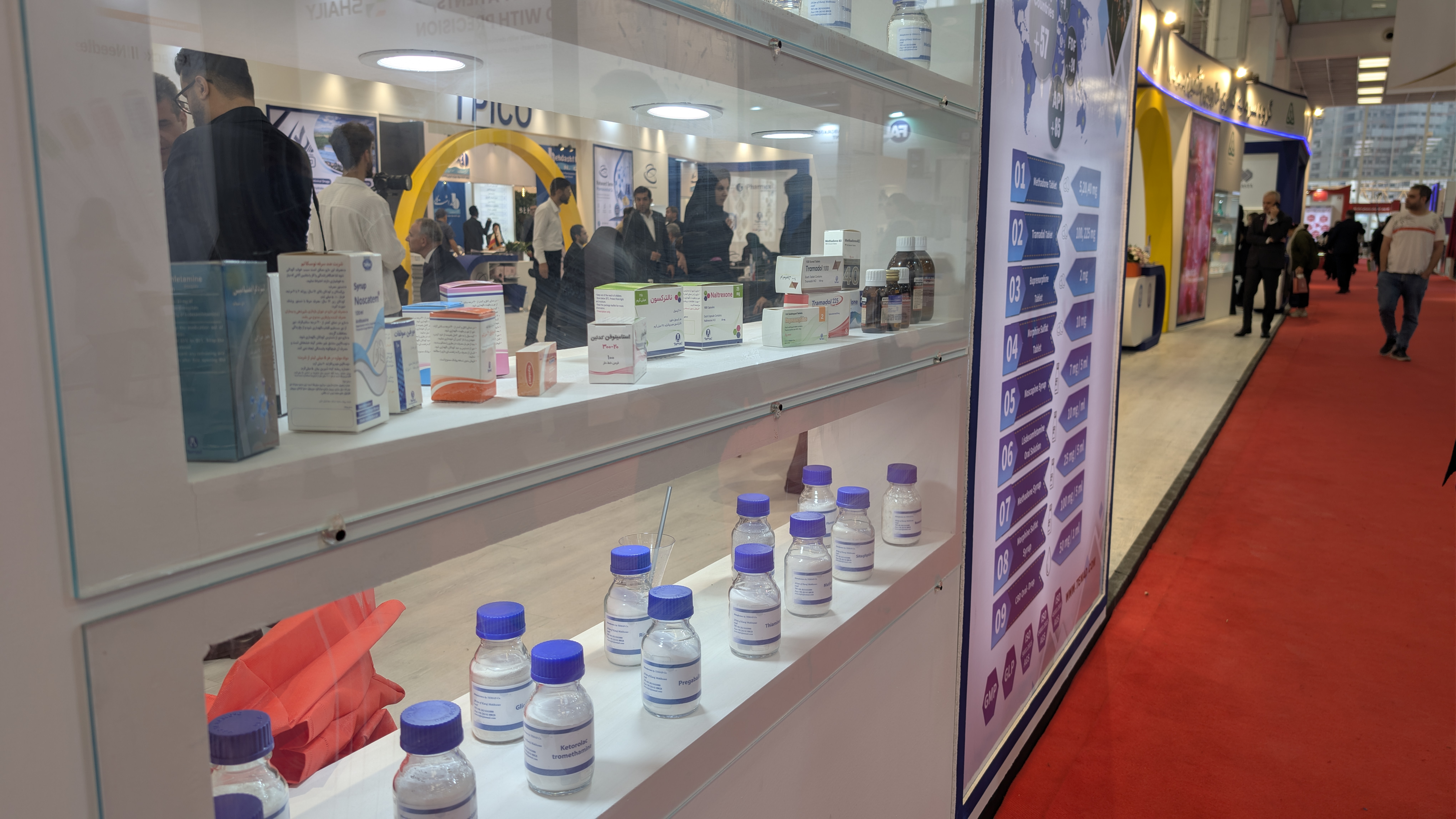 Pharmaceutical products on display in a glass window.