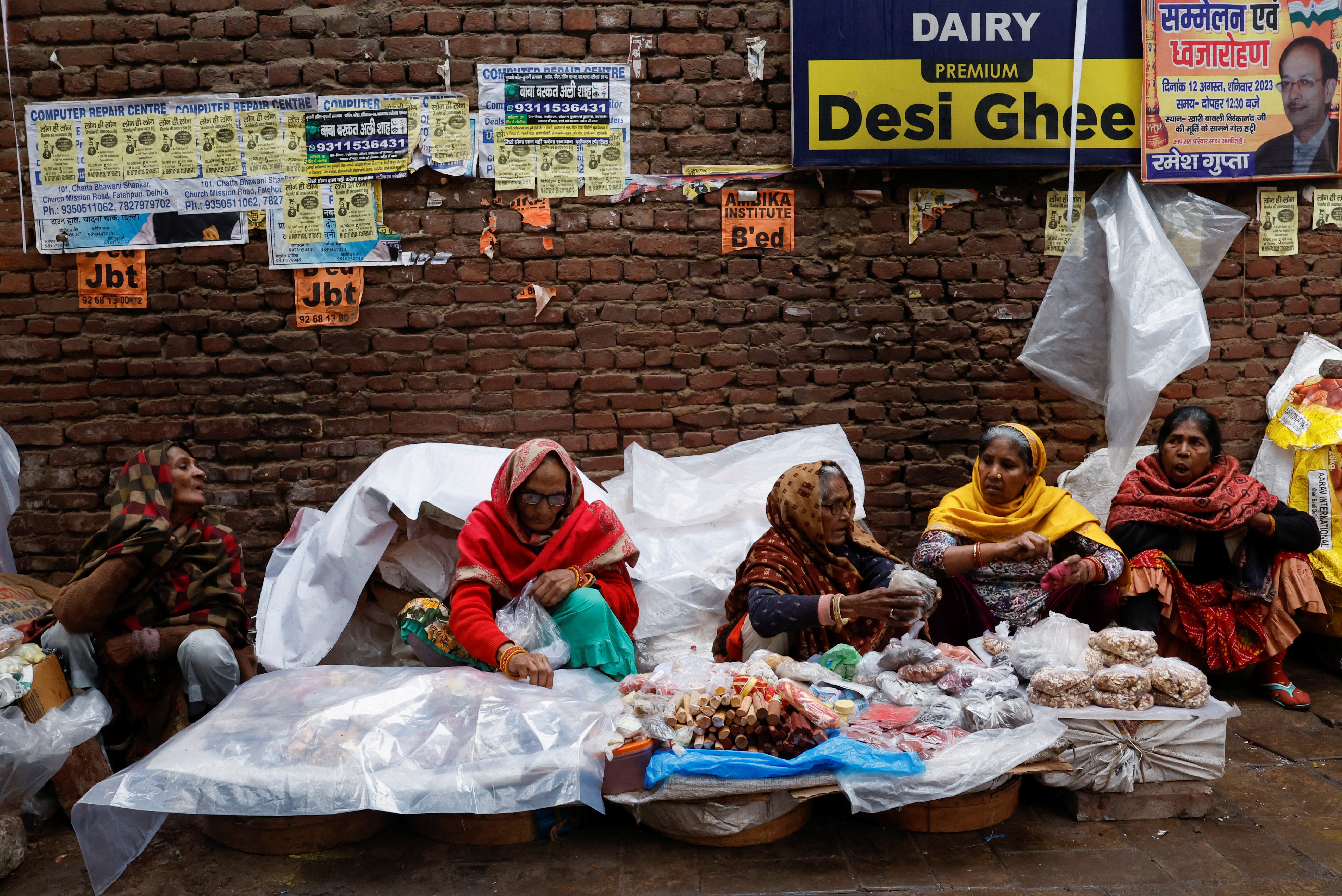 Women vendors wait for customers at a wholesale spices and dry fruits market, in the old quarters of Delhi, India, January 31, 2024 [Sahiba/ ChawdharyReuters]