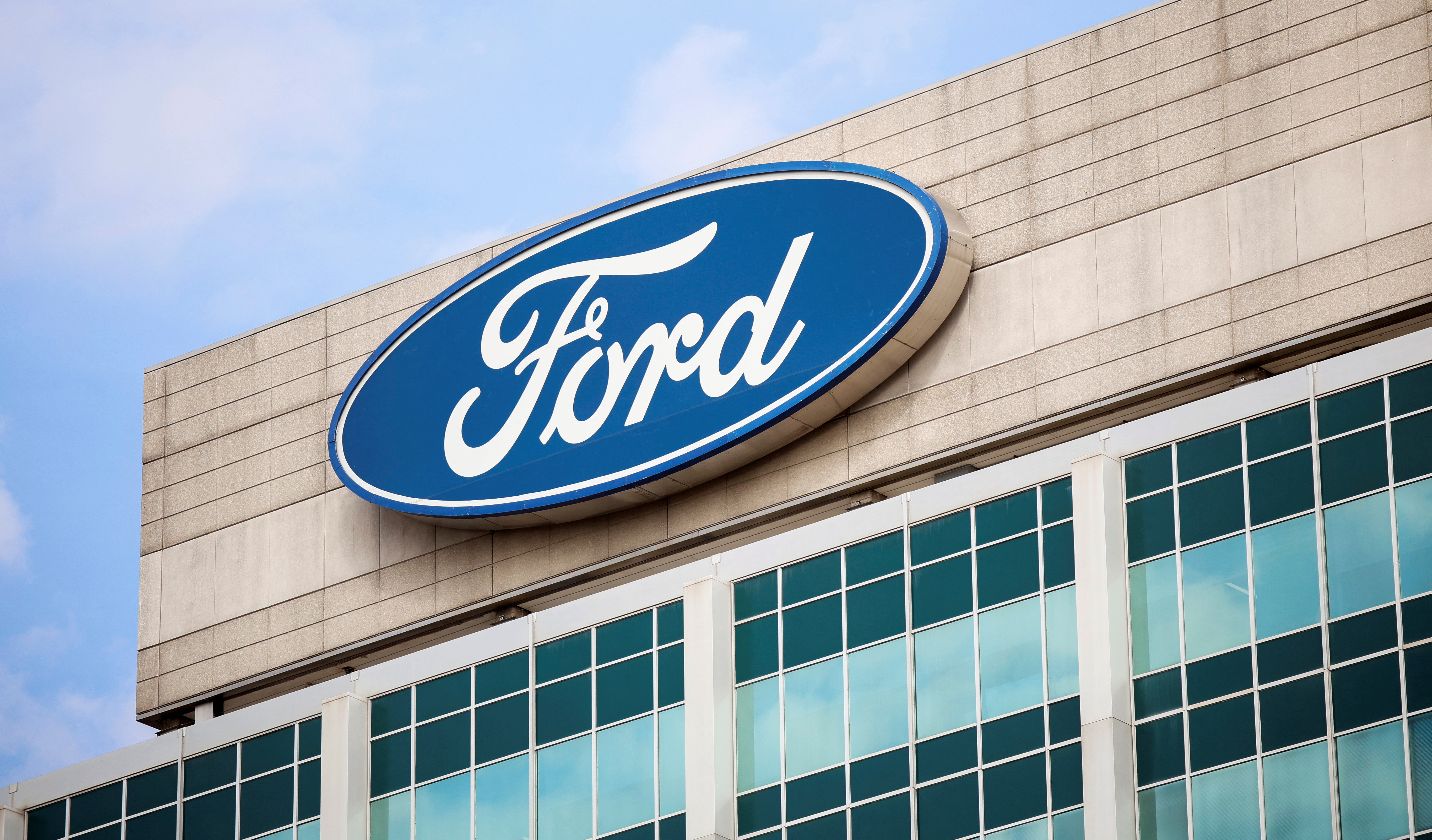 A Ford logo is seen on the Ford Motor World headquarters in Dearborn, Michigan, U.S., March 12, 2025. REUTERS/Rebecca Cook