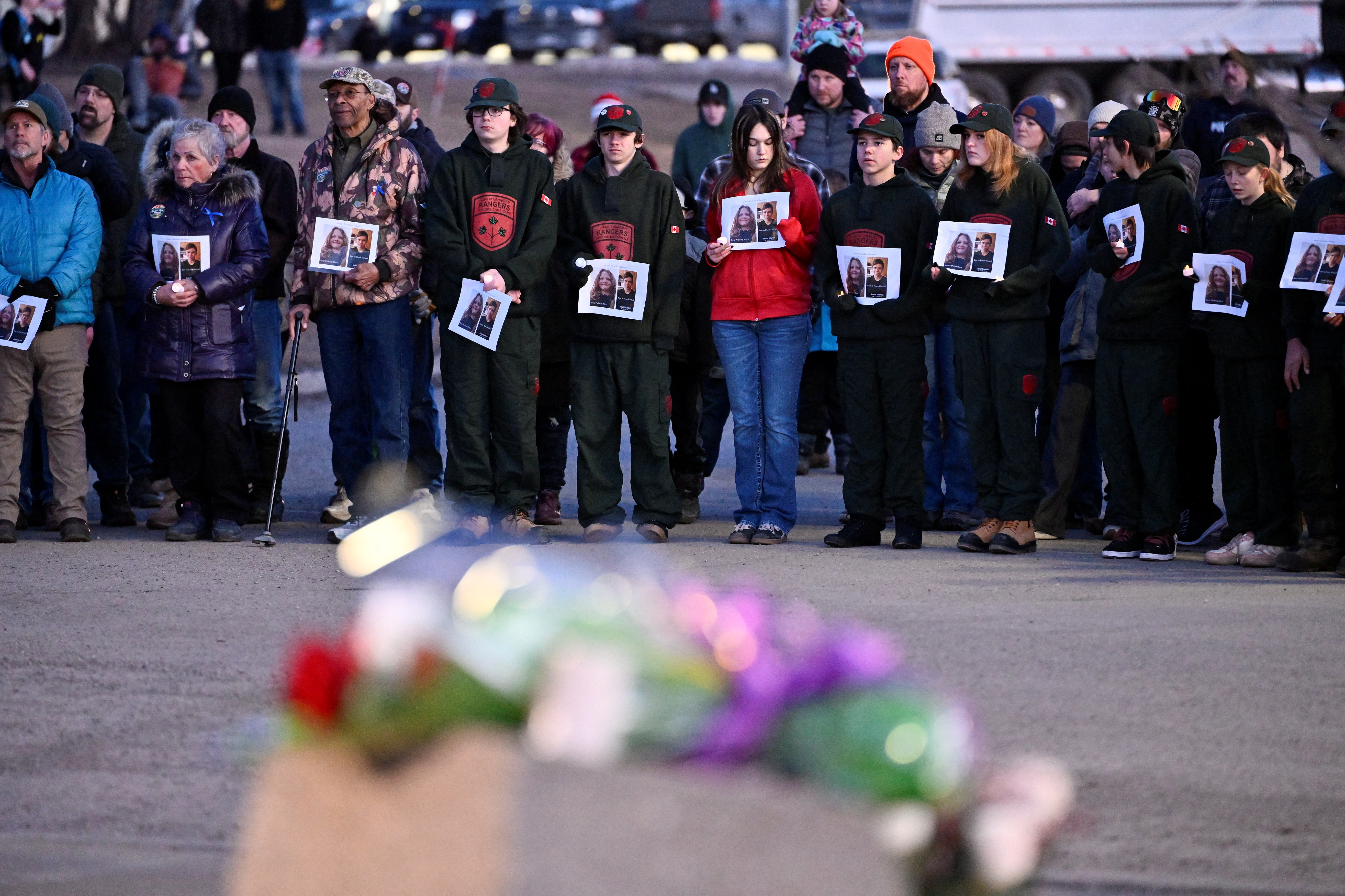 People attend a community vigil at a makeshift memorial at the town hall in Tumbler Ridge, British Columbia, Canada, on February 13, 2026