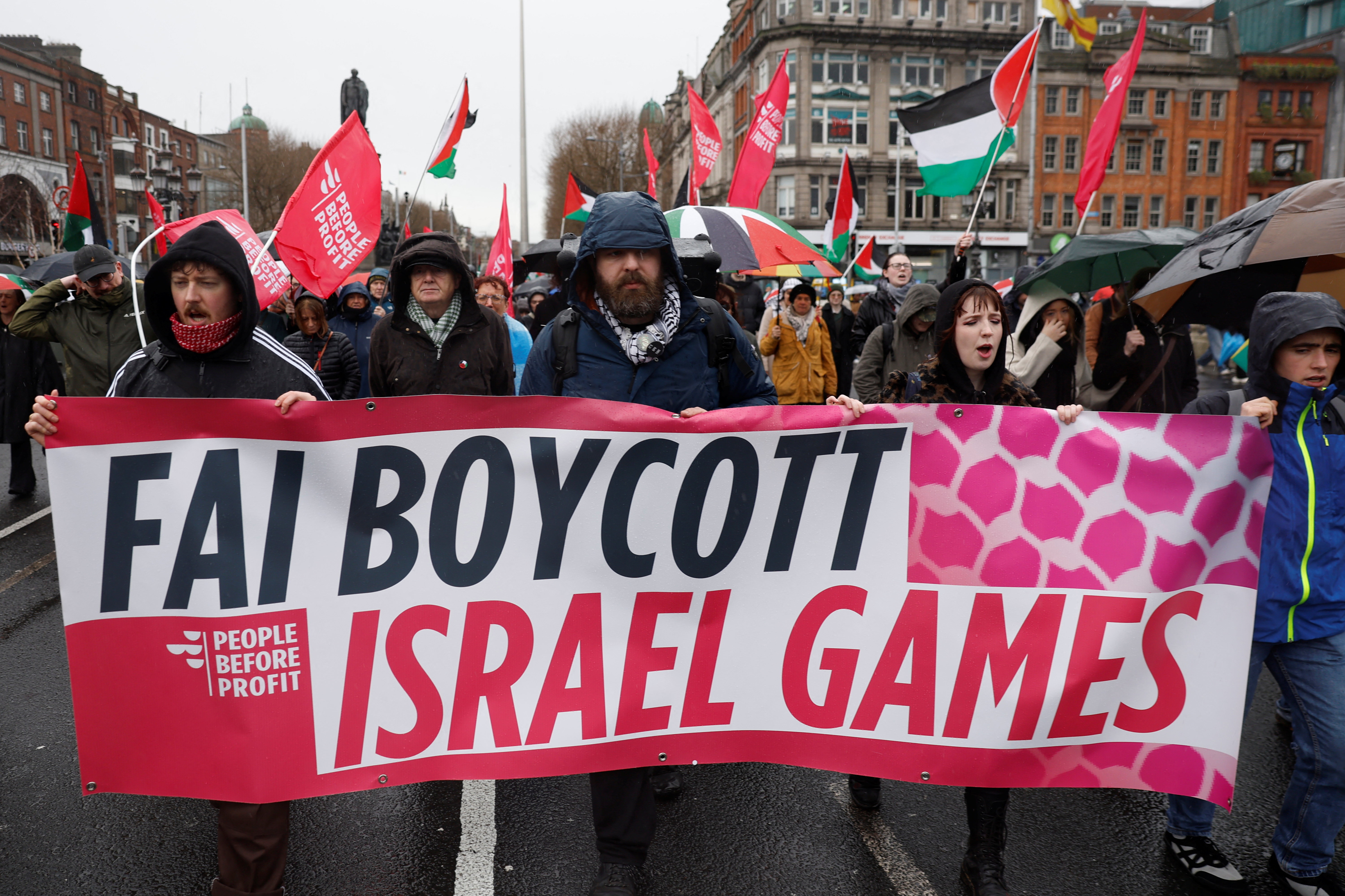 Demonstrators hold a banner urging the Football Association of Ireland (FAI) to boycott upcoming UEFA fixtures with Israel, in support of Palestinians during a protest in relation to the ceasefire in Gaza, in Dublin, Ireland, February 21, 2026. REUTERS/Clodagh Kilcoyne