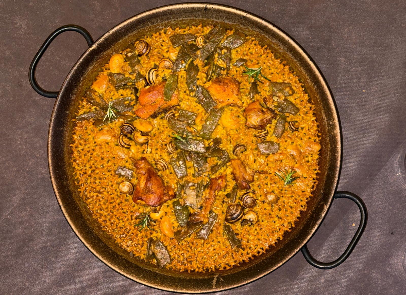 A Paella valenciana, made with rabbit, chicken, snails, and vegetables is served at La Matandeta restaurant in Valencia, Spain, January 4, 2026. REUTERS/Maria Martinez
