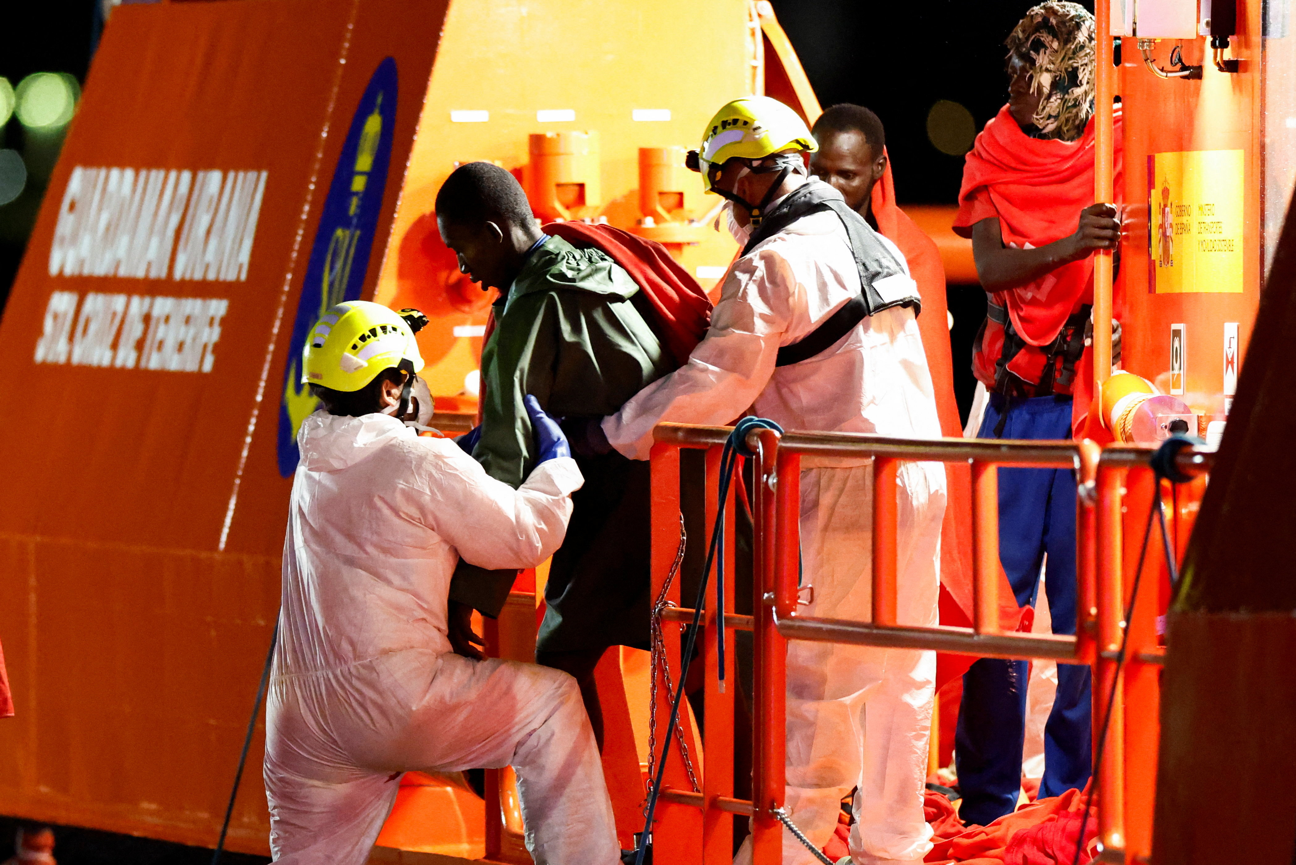 Rescuers help a migrant disembark from a Spanish coast guard vessel at the port of Arguineguin, on the island of Gran Canaria, Spain on September 3, 2026.