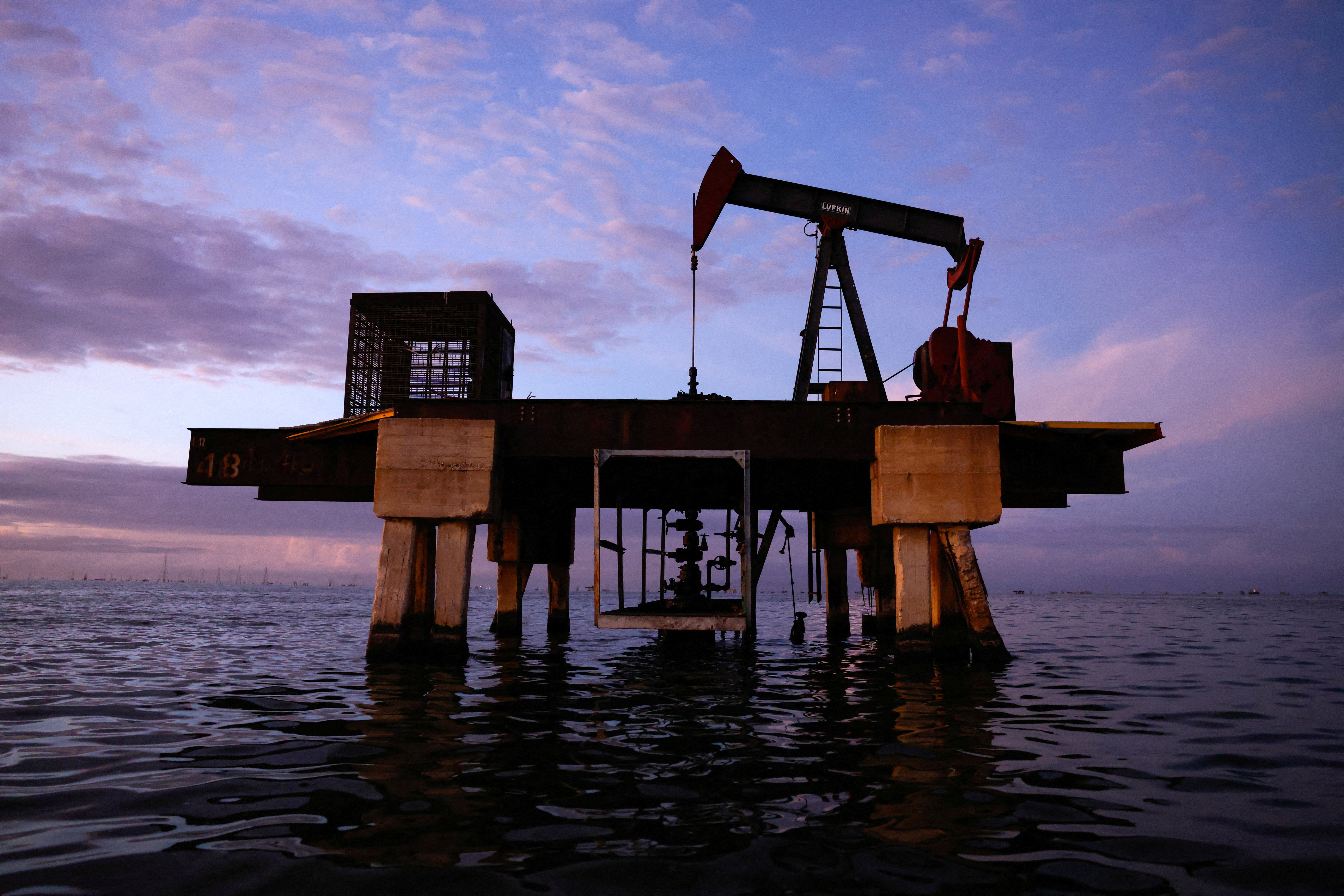 An oil pumpjack in the water.