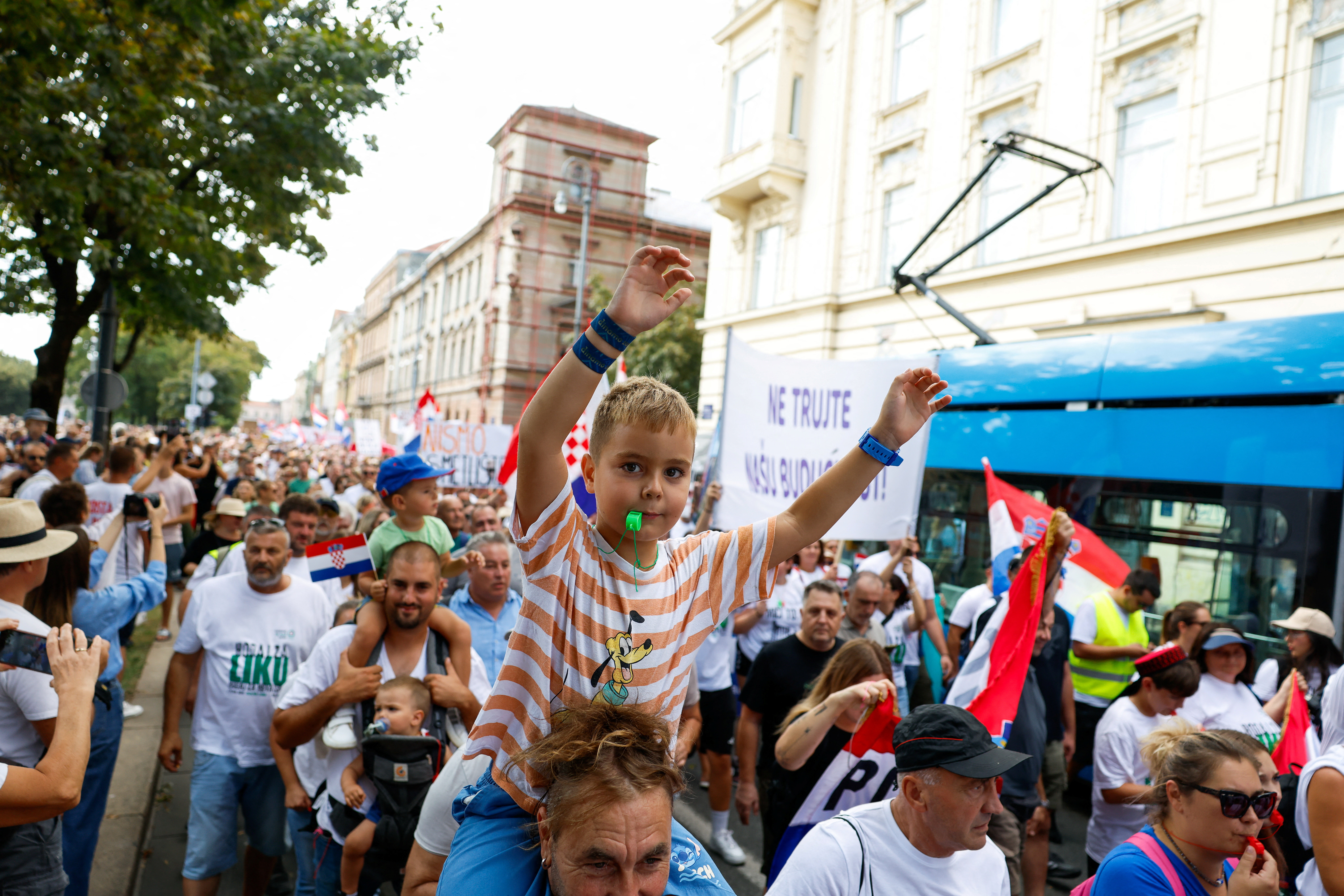 Demonstrators fill a central square in Zagreb, carrying banners against the government’s handling of the Gospic waste site