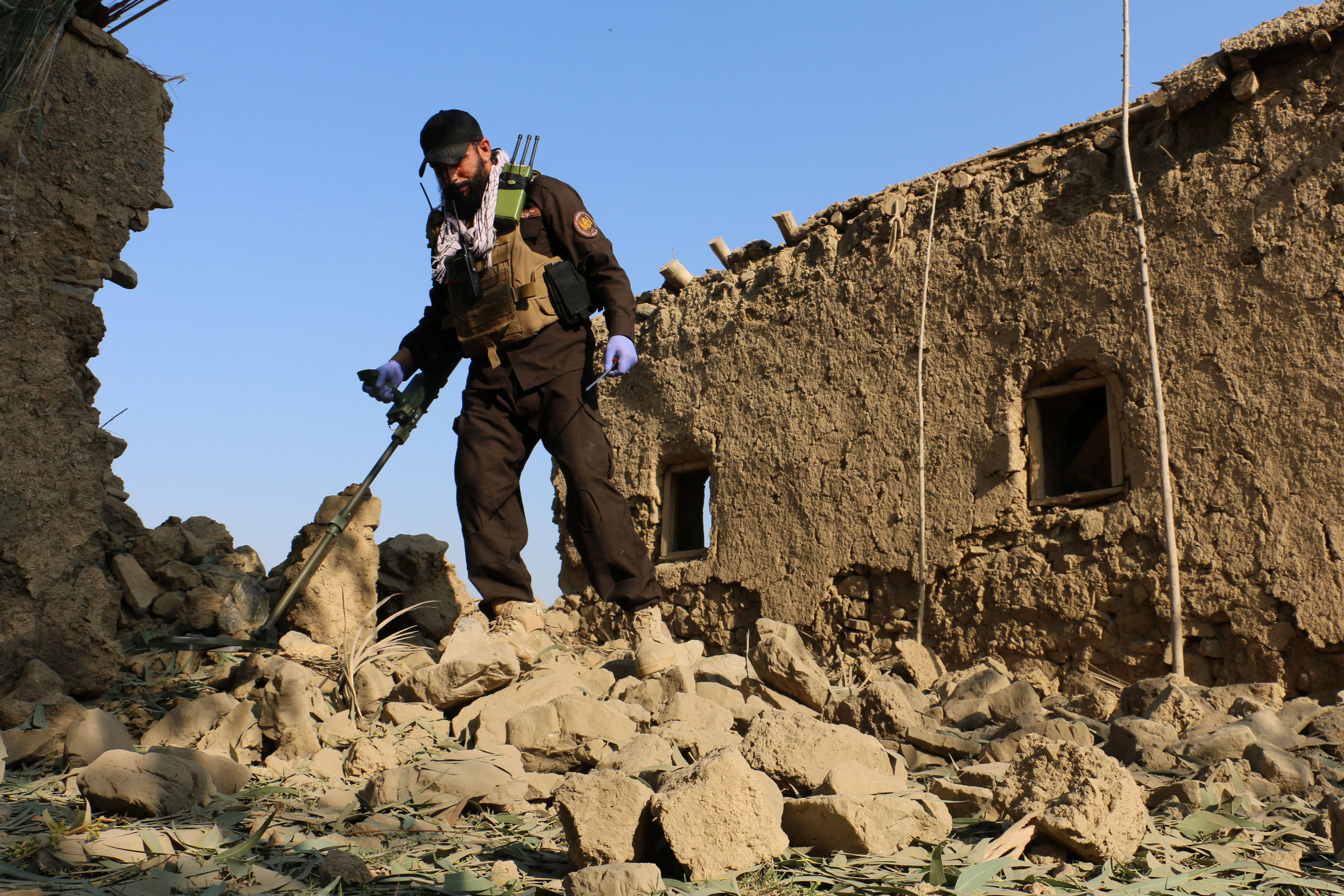 A member of Taliban security forces uses a metal detector amid the rubble of a house that was damaged in what the Taliban said was a Pakistani airstrike in Gurbuz district of Khost province, Afghanistan, September 24, 2026 [Reuters]