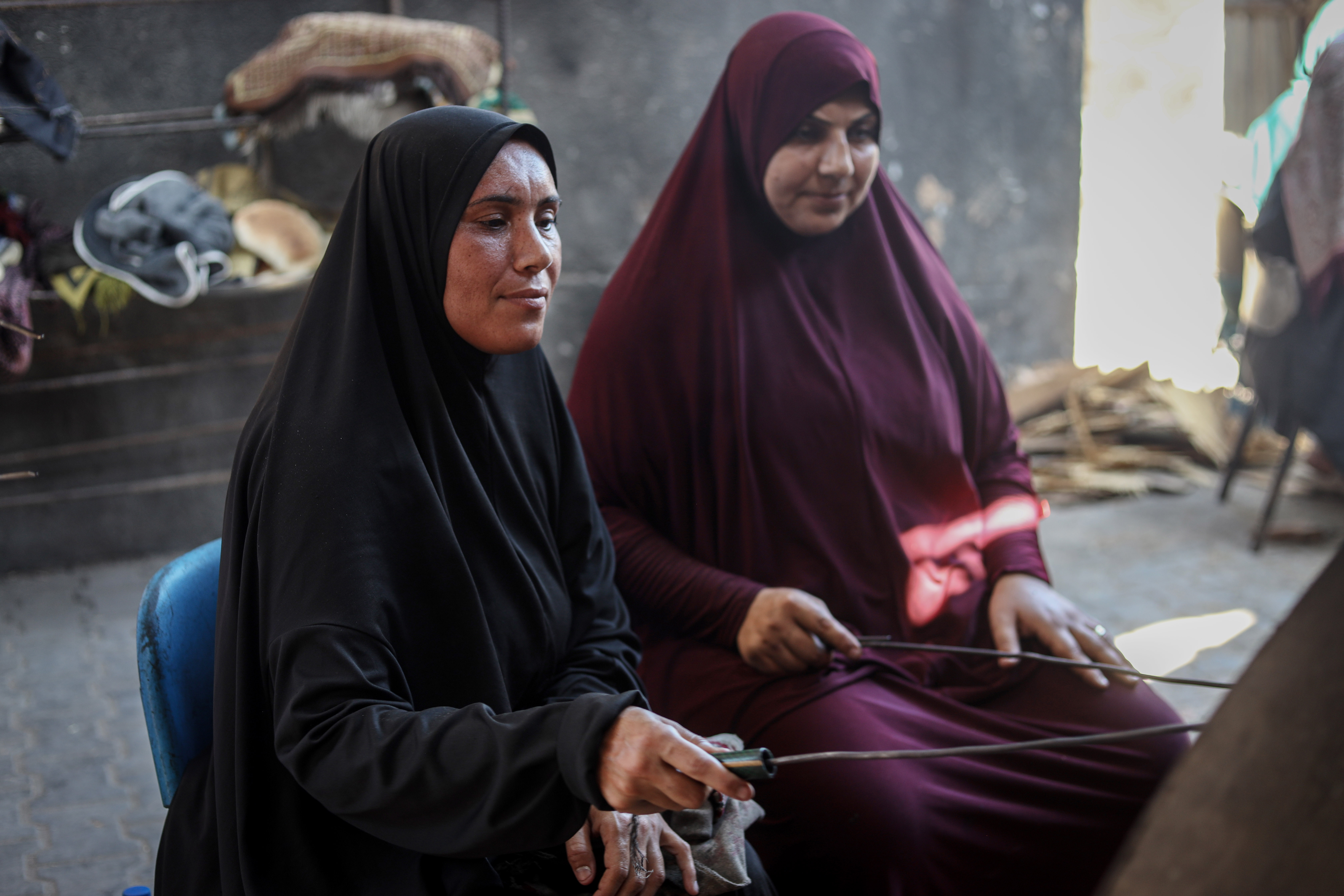 Randa Adwan, 39, works at a communal oven at a school shelter in Gaza, baking bread for displaced families