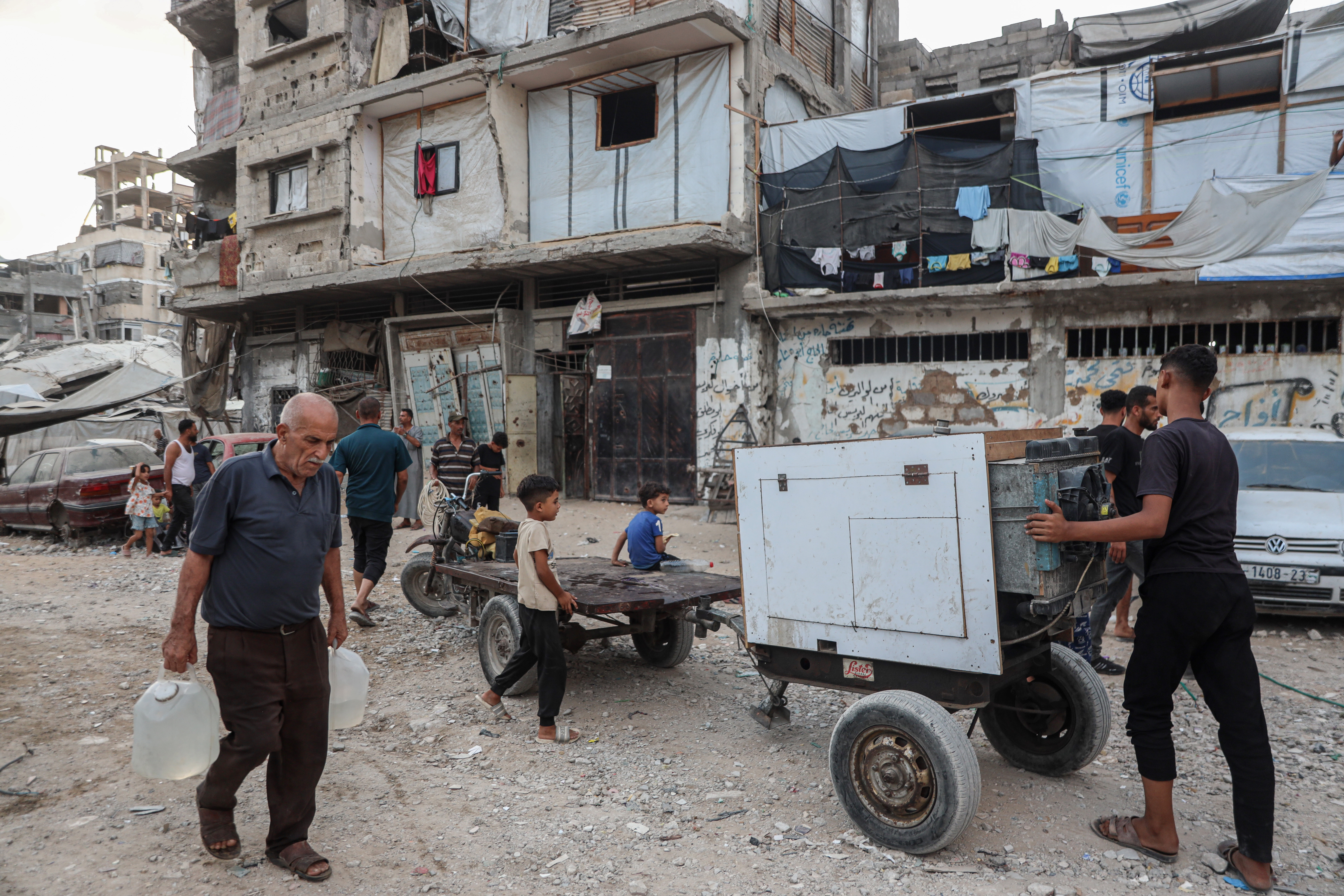 A generator passes through a northern Gaza neighbourhood [Abdelhakim Abu Riash/ Al Jazeera]