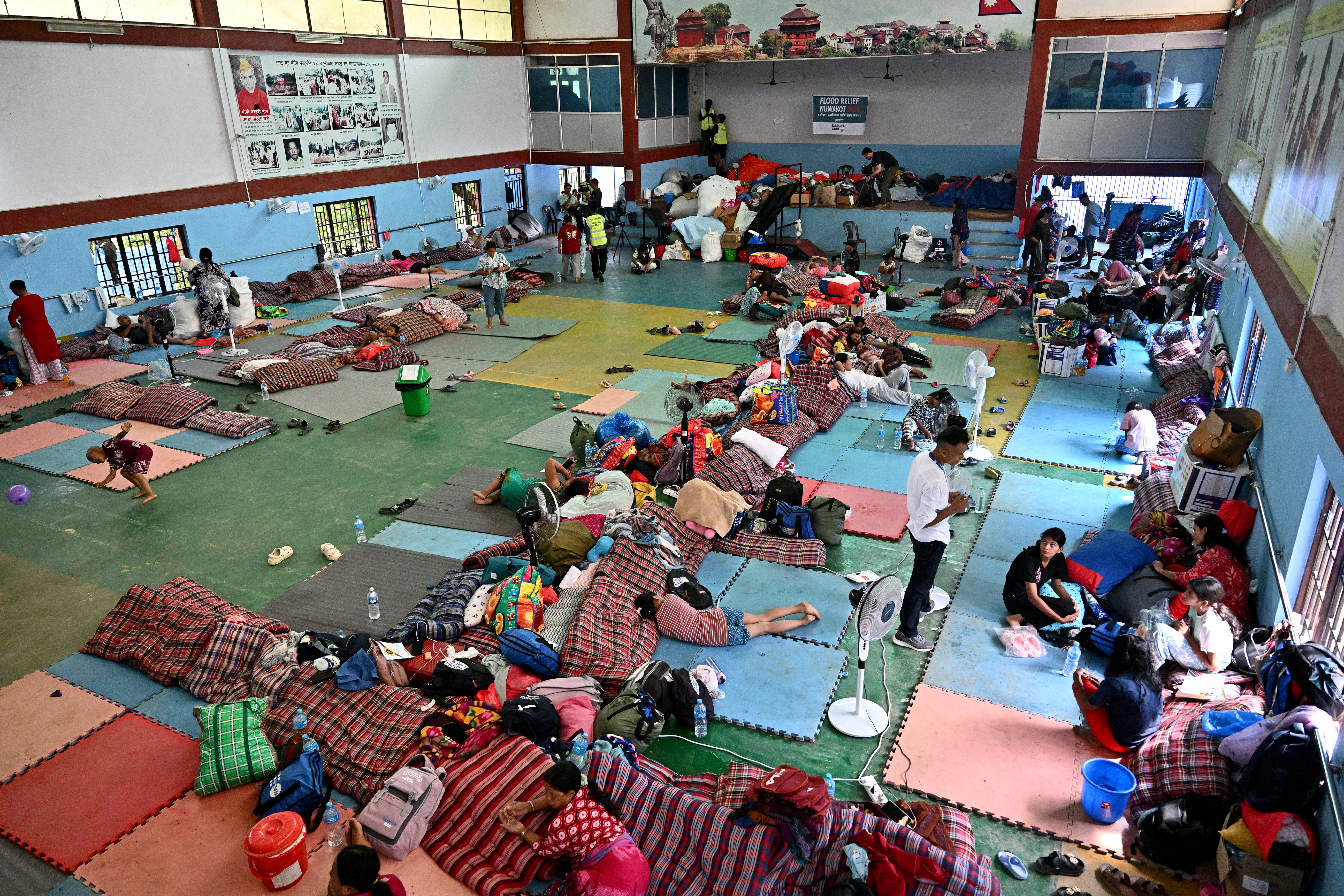 Flash flood survivors rest inside a relief shelter at Devighat in Nepal's Nuwakot district on September 6, 2026 [Pedro PARDO / AFP]