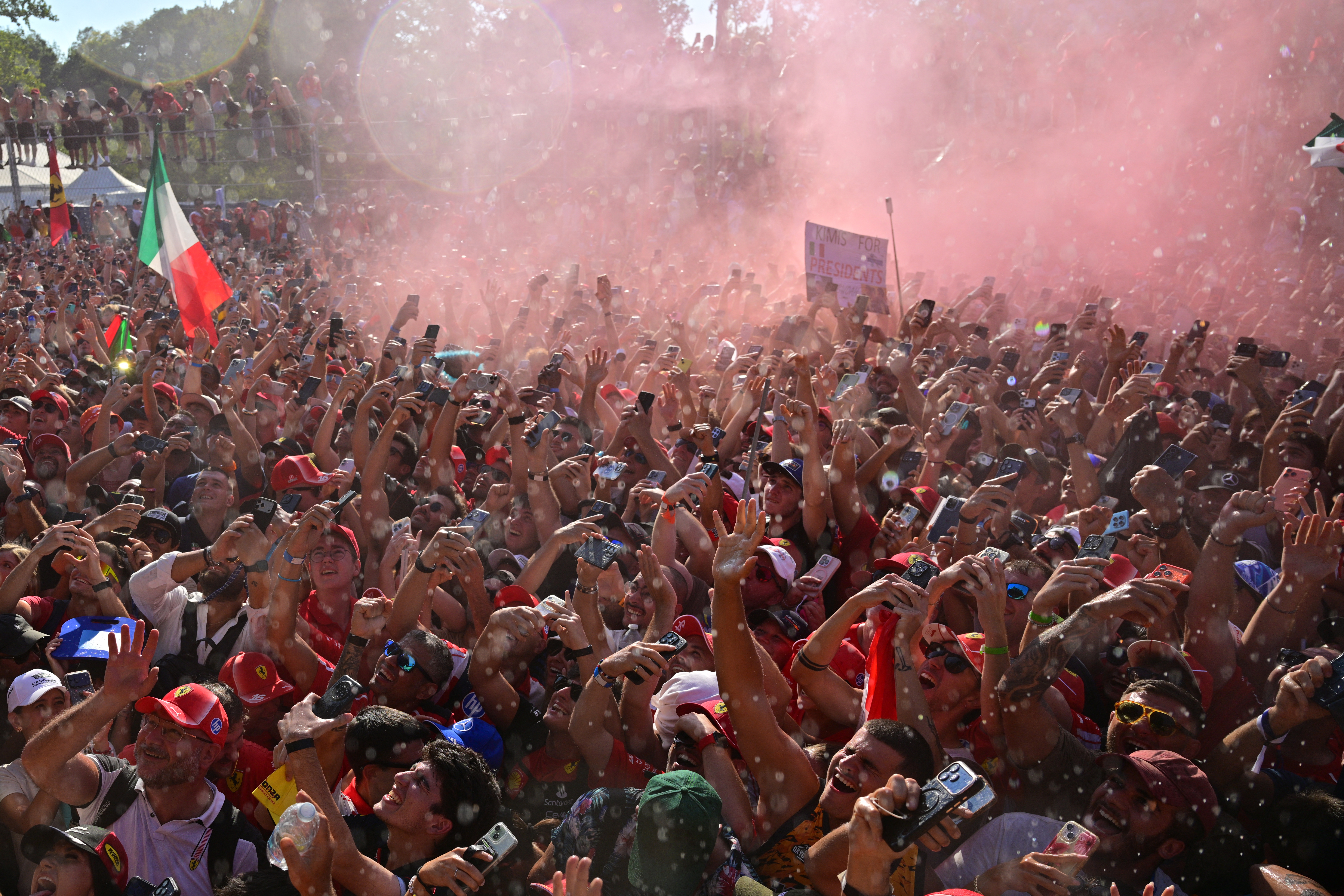 Fans cheer as the race winner Mercedes' Italian driver Kimi Antonelli spraus champagne after the Italian Formula One Grand Prix at the Autodromo Nazionale Monza circuit in Monza, northern Italy on September 6, 2026. (Photo by Andrej ISAKOVIC / AFP)