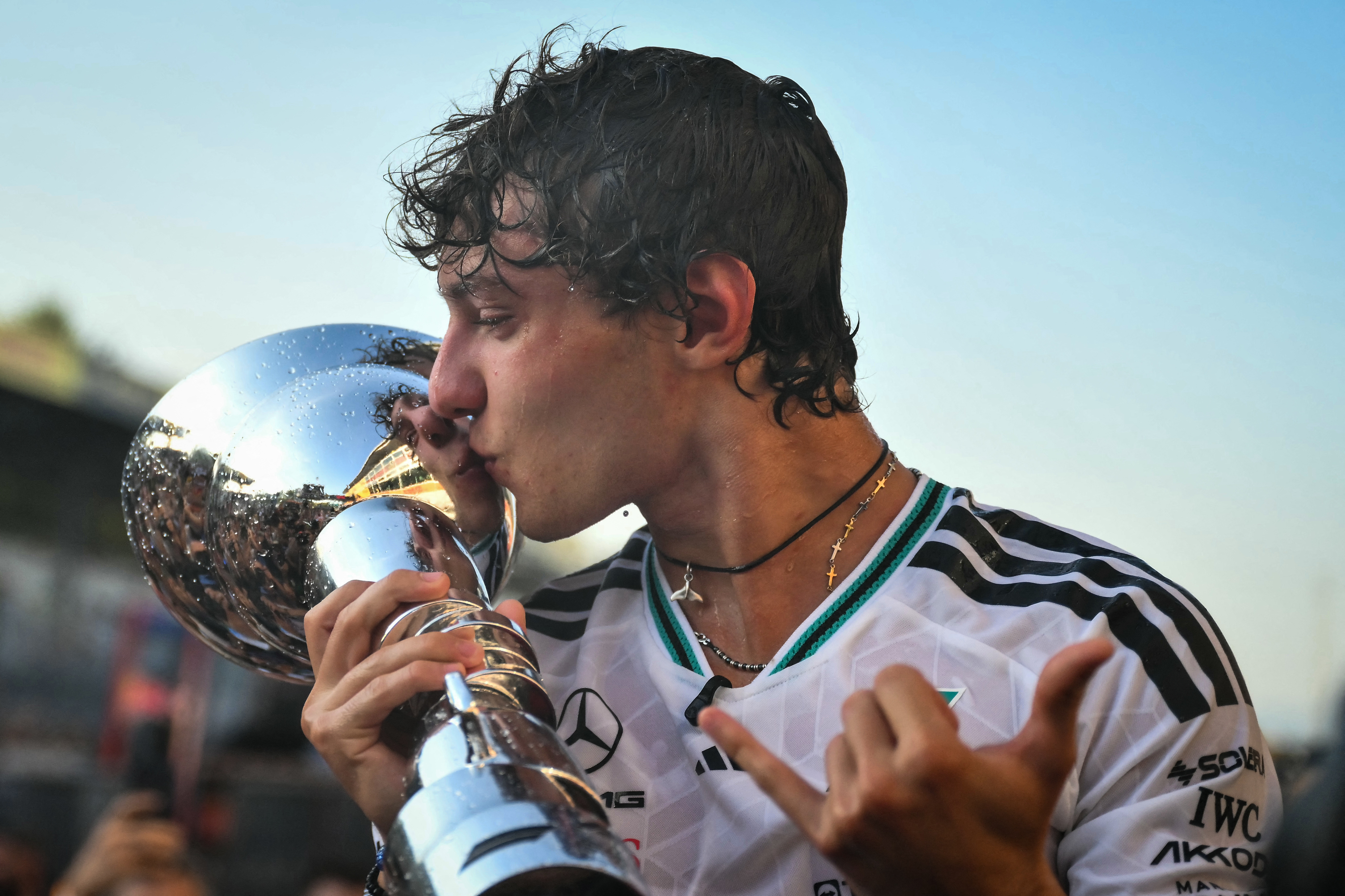 Mercedes' Italian driver Kimi Antonelli kisses the trophy as he celebrates with his team members after winning the Italian Formula One Grand Prix at the Autodromo Nazionale Monza circuit in Monza, northern Italy on September 6, 2026. (Photo by Marco BERTORELLO / AFP)