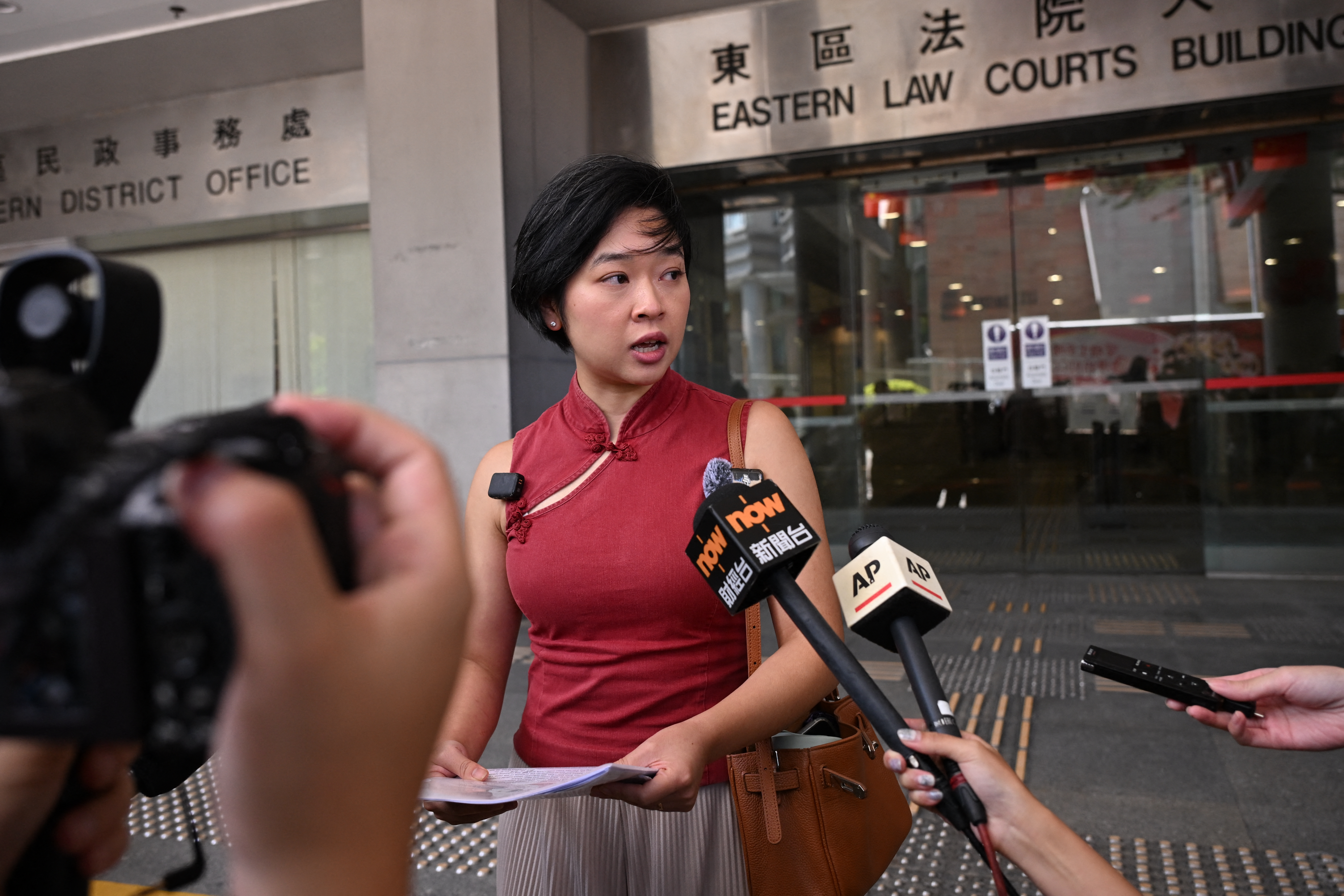 Former Wall Street Journal reporter Selina Cheng (C) speaks to reporters.