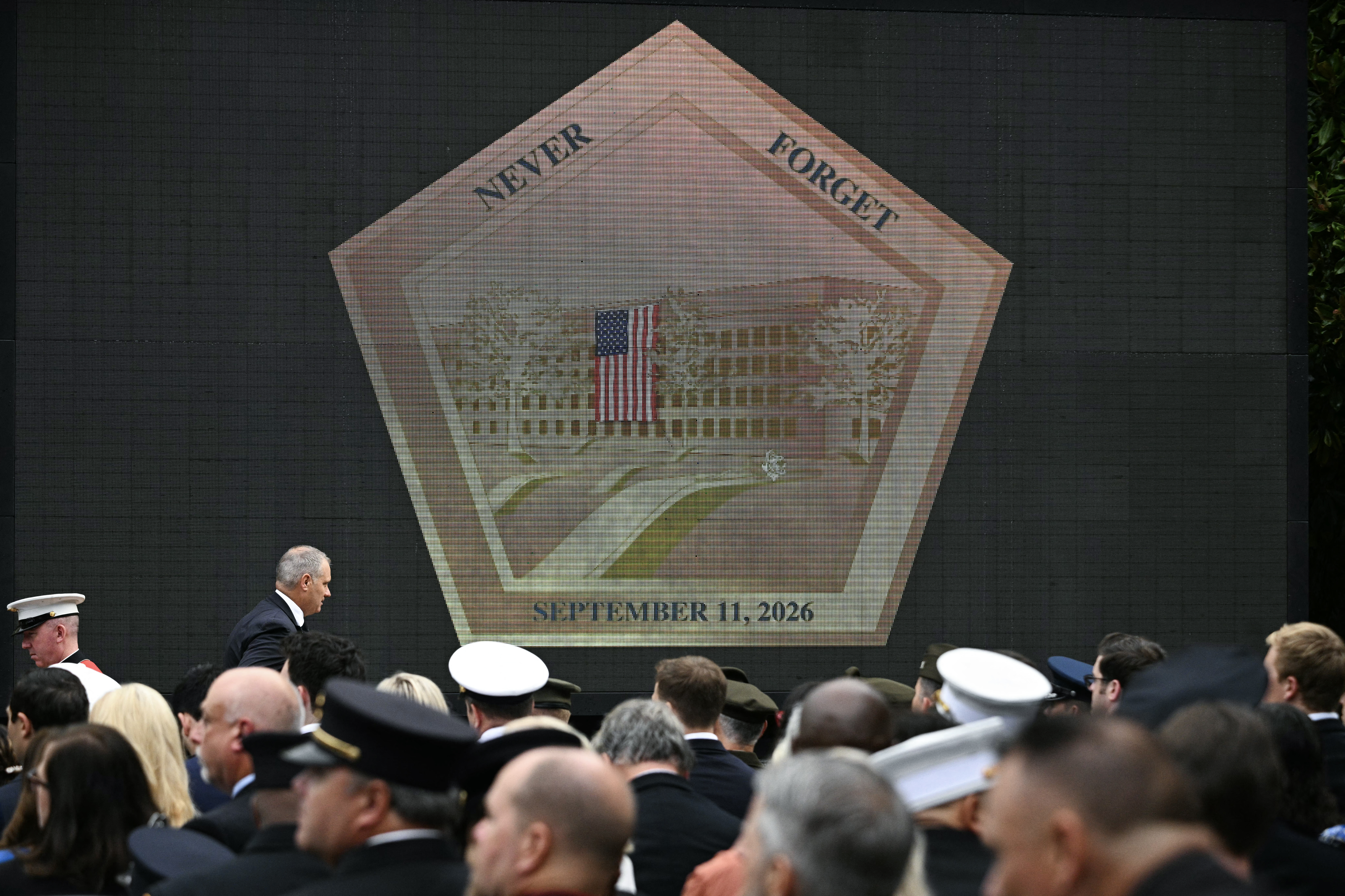 A screen shows a pentagon logo commemorating the 25th anniversary of the September 11, 2001 attacks at the Pentagon in Washington, DC, on September 11, 2026. (Photo by Jim WATSON / AFP)