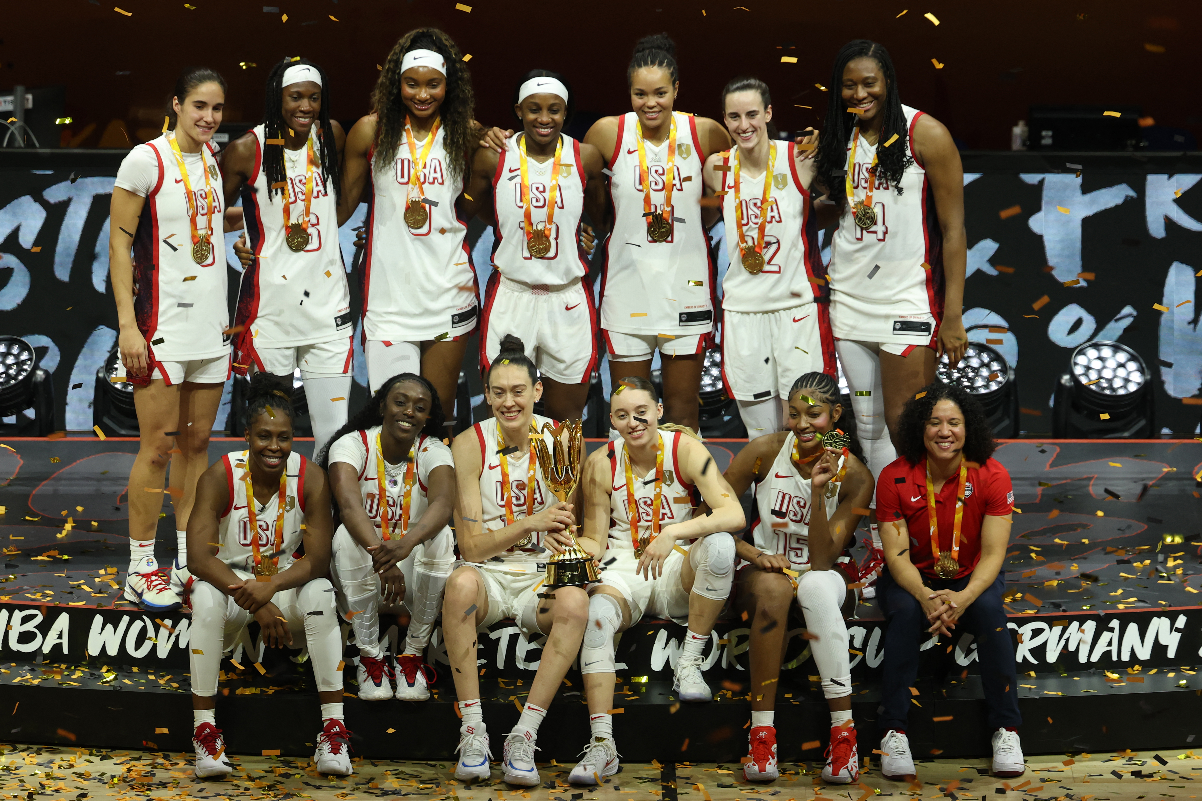 US' team poses with the world cup trophy during the medal ceremony following the 2026 FIBA Womens Basketball World Cup final game between the United States and France in Berlin on September 13, 2026. (Photo by Odd ANDERSEN / AFP)