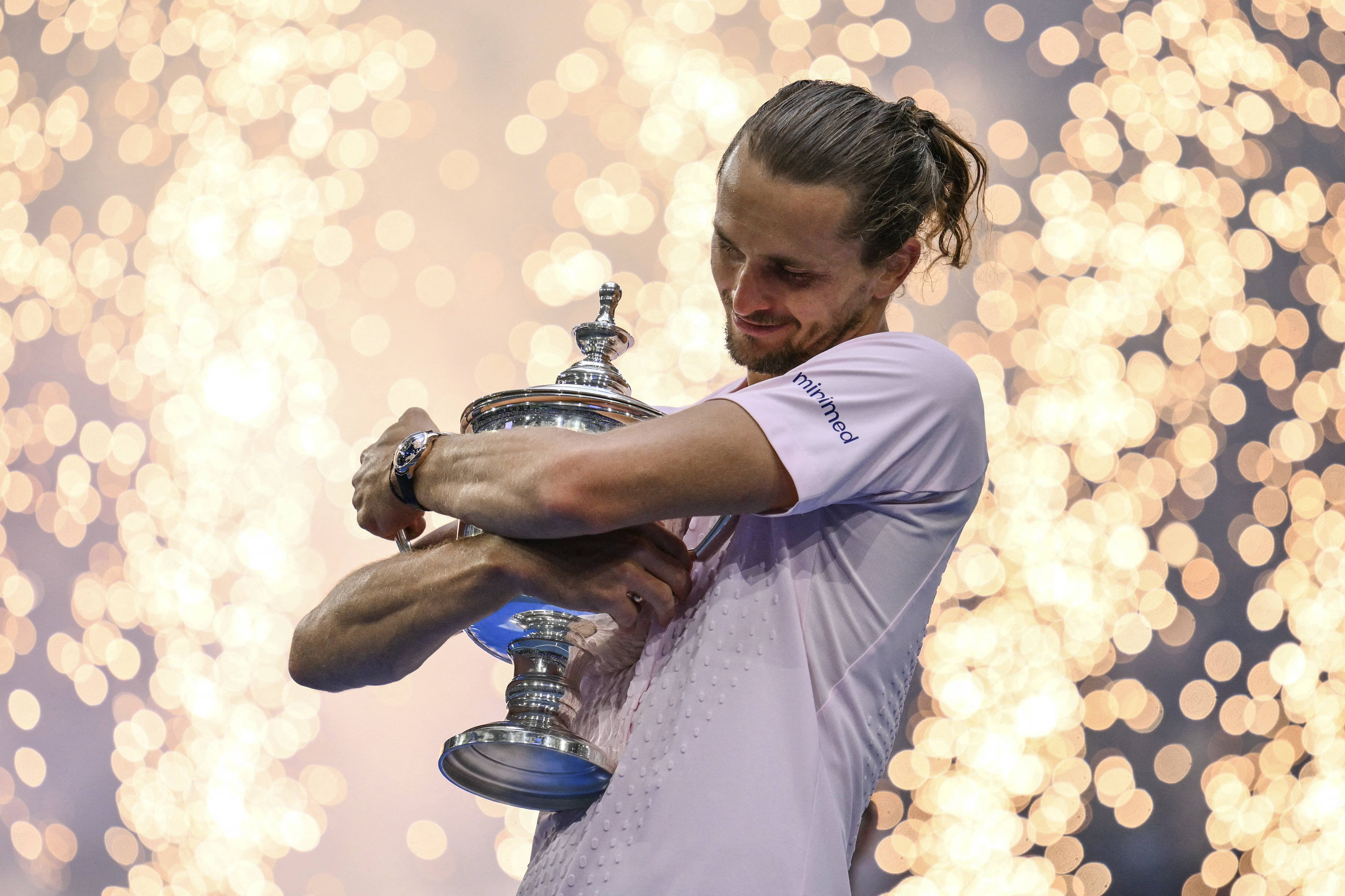 Germany's Alexander Zverev hugs the trophy after defeating USA's Ben Shelton in the men's singles final tennis match on day fifteen of the US Open tennis tournament at the USTA Billie Jean King National Tennis Center in New York on September 13, 2026. (Photo by ANGELA WEISS / AFP)