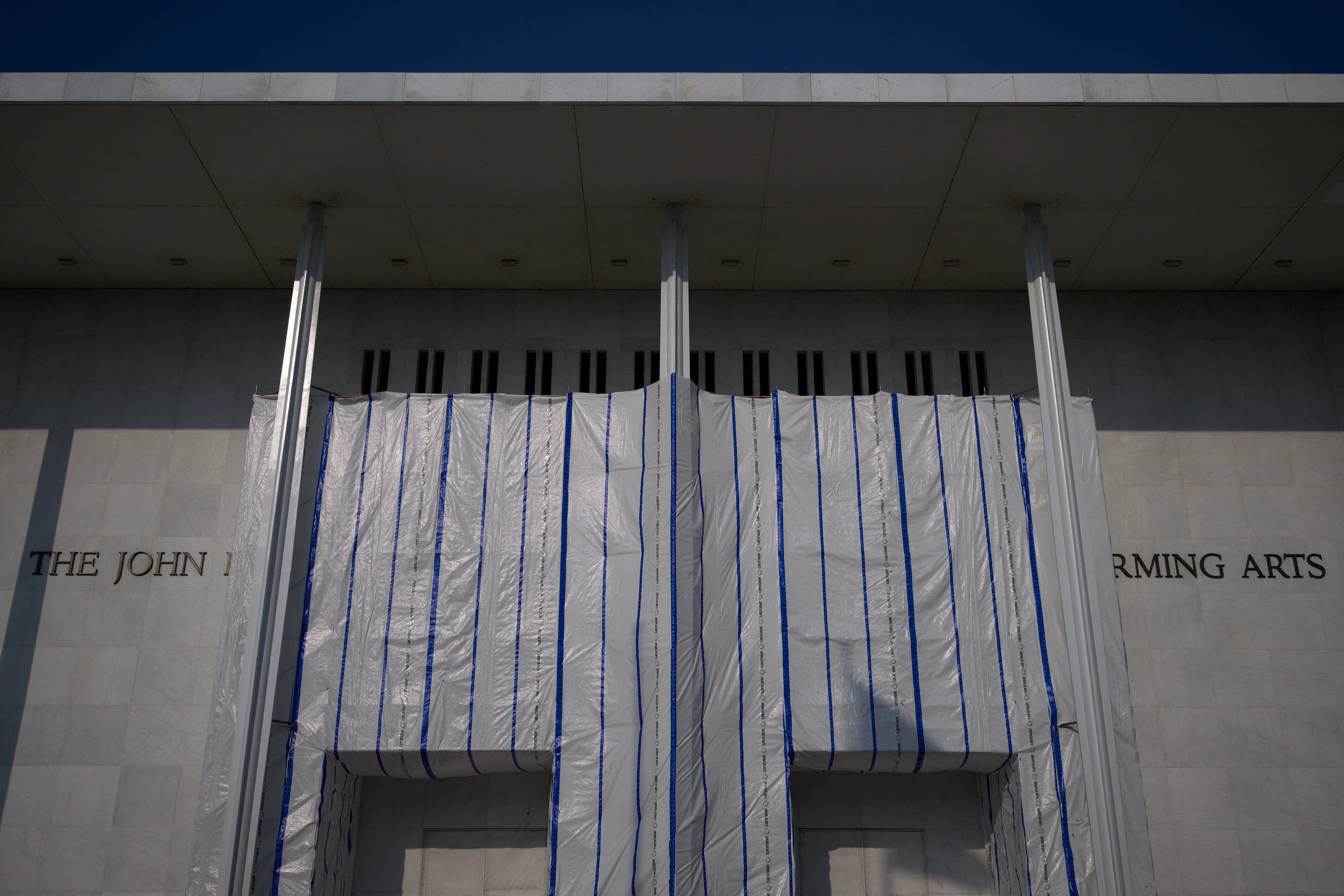 Scaffolding is seen on the main building of the John F. Kennedy Center for the Performing Arts in Washington, DC, on September 17, 2026. On September 15, US President Donald Trump threatened to keep the Kennedy Center closed for good after a judge ruled his name cannot be added onto the famed arts institution's facade. Trump said his hand-picked board voted "almost unanimously" to shut the venue immediately for emergency renovations, just a few hours after the federal judge's decision. But he warned the "very large and complex" repairs at the building in Washington cannot begin until a higher court rules on whether the center can be renamed after himself. (Photo by Kent Nishimura / AFP)