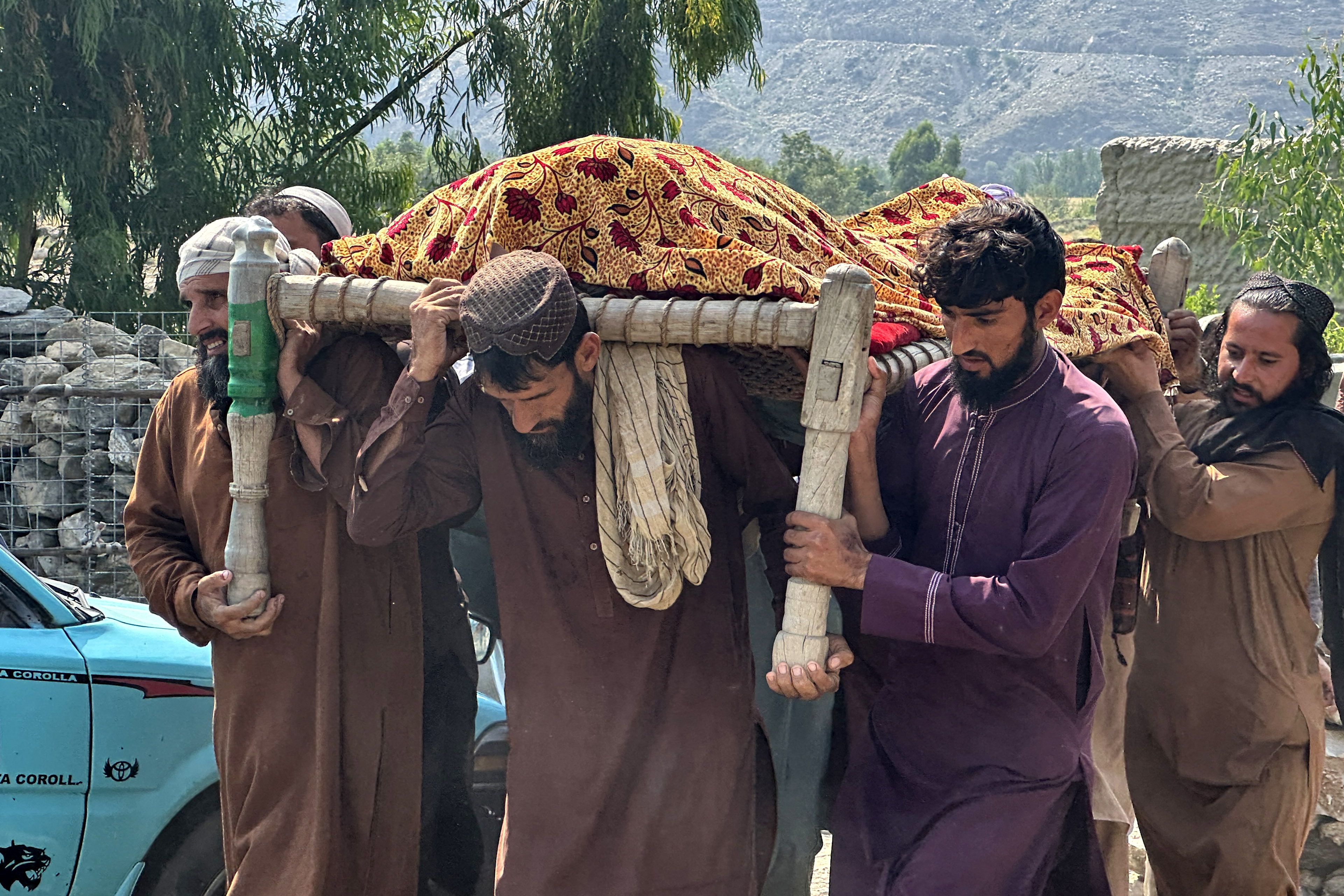 Afghans carry the body of a victim
