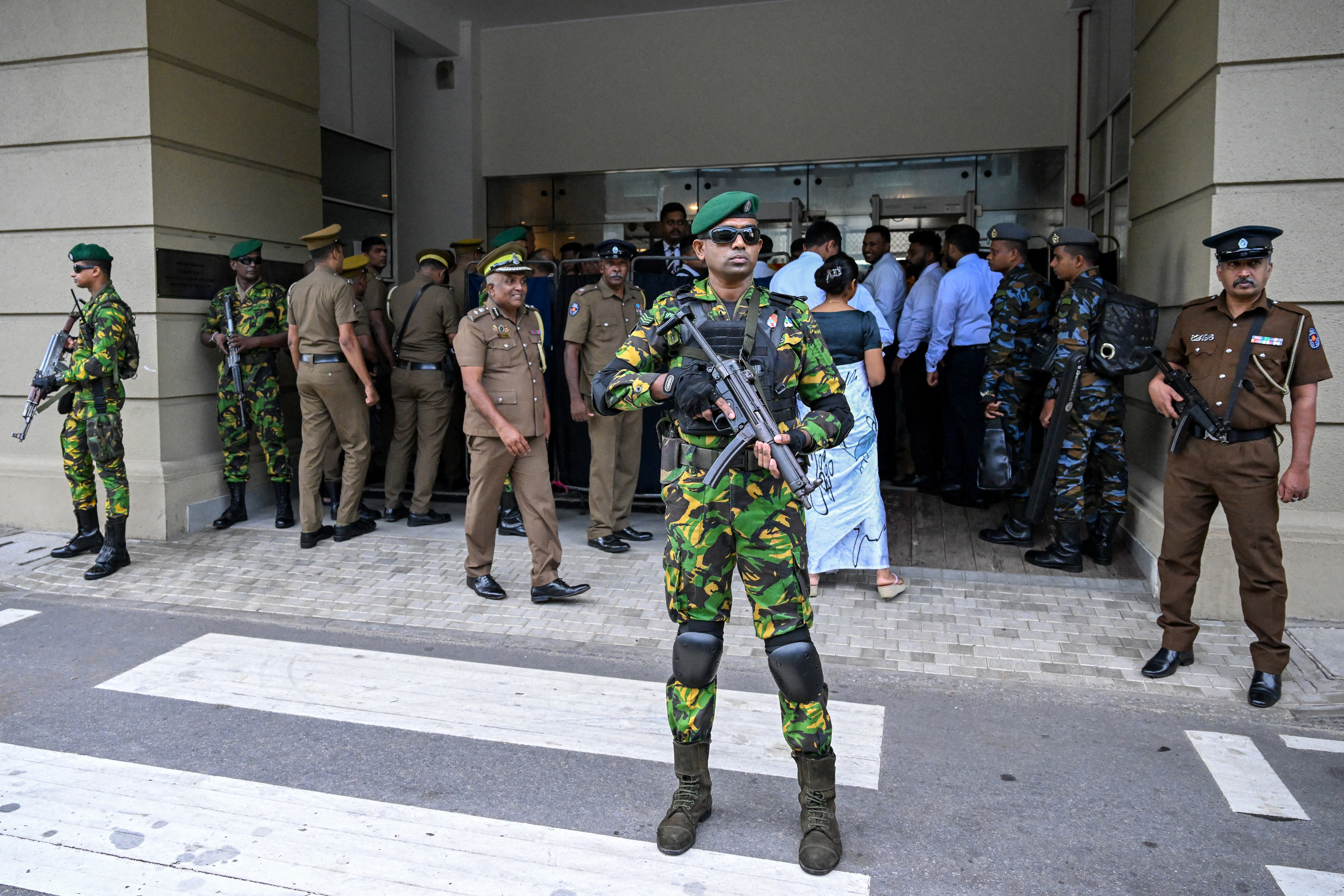Security personnel stand guard outside Colombo High Court after escorting the accused involved in Sri Lanka's Easter Sunday attacks of 2019, during the verdict in the trial in Colombo on September 22, 2026 [Ishara S. Kodikara/AFP]