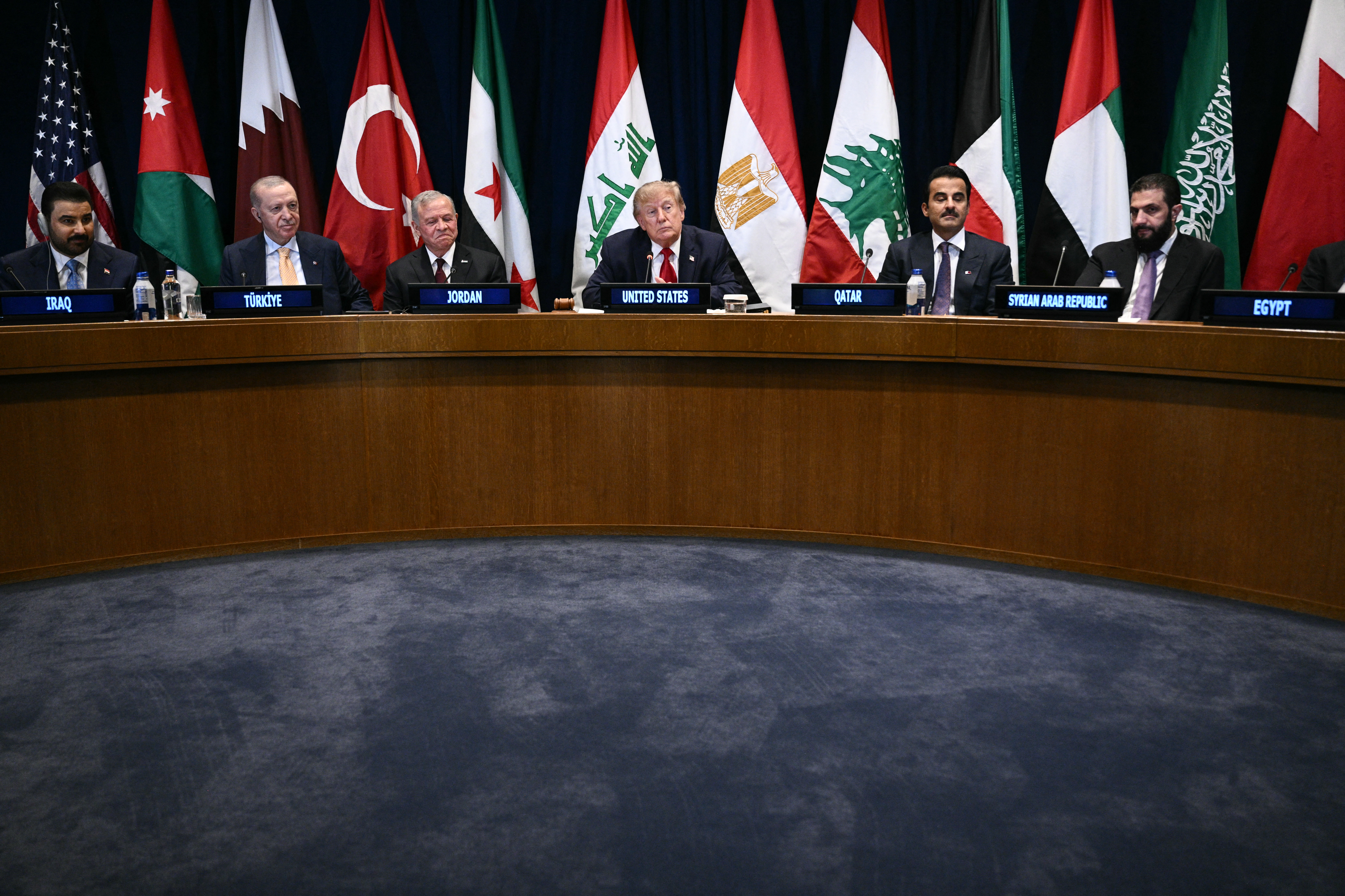 US President Donald Trump (C) attends a Gulf Cooperation Council (GCC) multilateral meeting alongside (L/R) Iraqi Prime Minister Ali al-Zaidi, Turkey's President Recep Tayyip Erdogan, King Abdullah II of Jordan, Qatar's Emir Sheikh Tamim bin Hamad al-Thani and Syrian President Ahmed al-Sharaa on the sidelines of the 81st United Nations General Assembly in New York on September 22, 2026. (Photo by Brendan SMIALOWSKI / AFP)