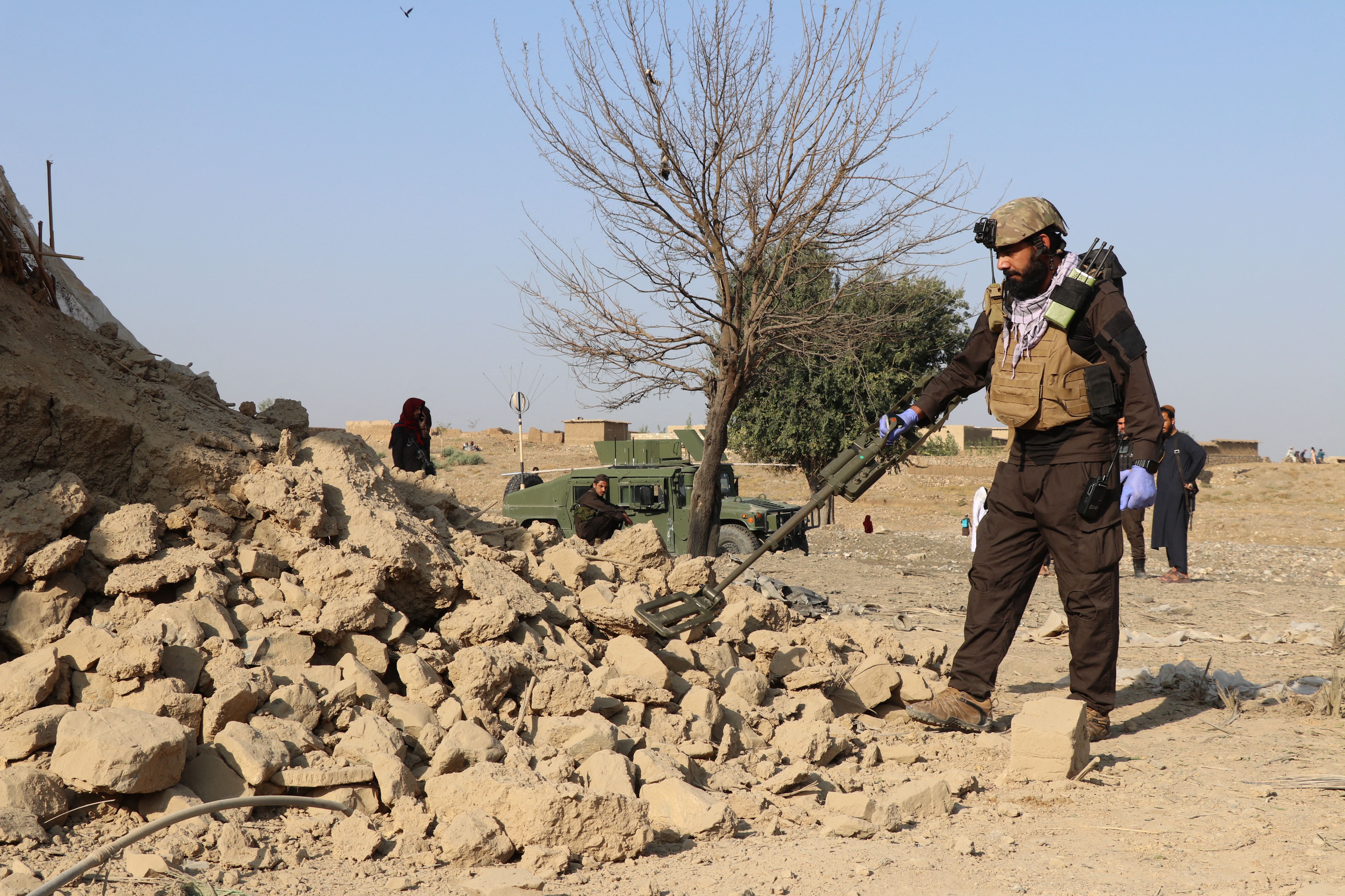 Security personnel inspects the site of a strike in Gurbuz district in Afghanistan's Khost province