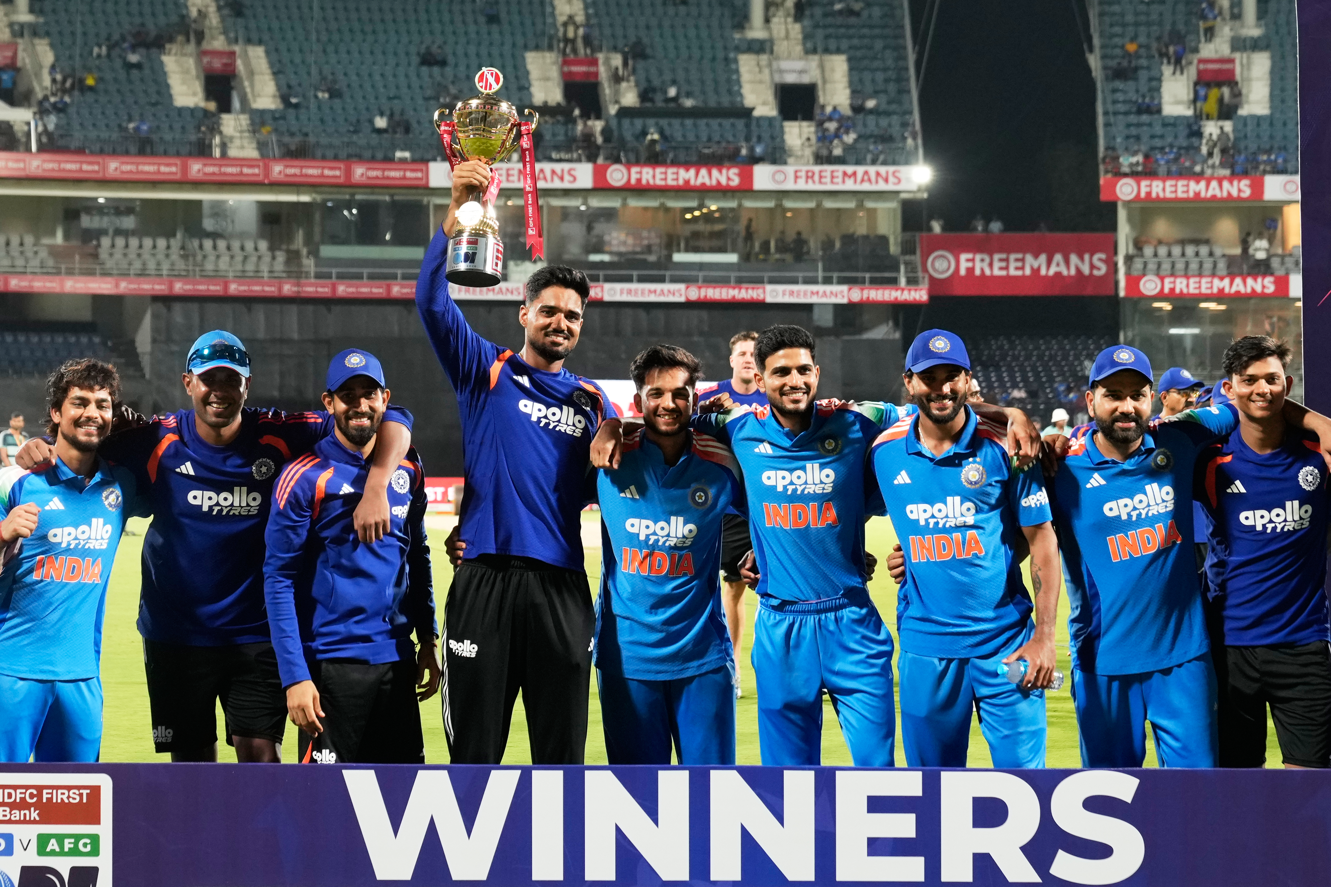 India's Gurnoor Brar carries the winners' trophy as he poses for a photo with teammates after India won the ODI cricket series against Afghanistan
