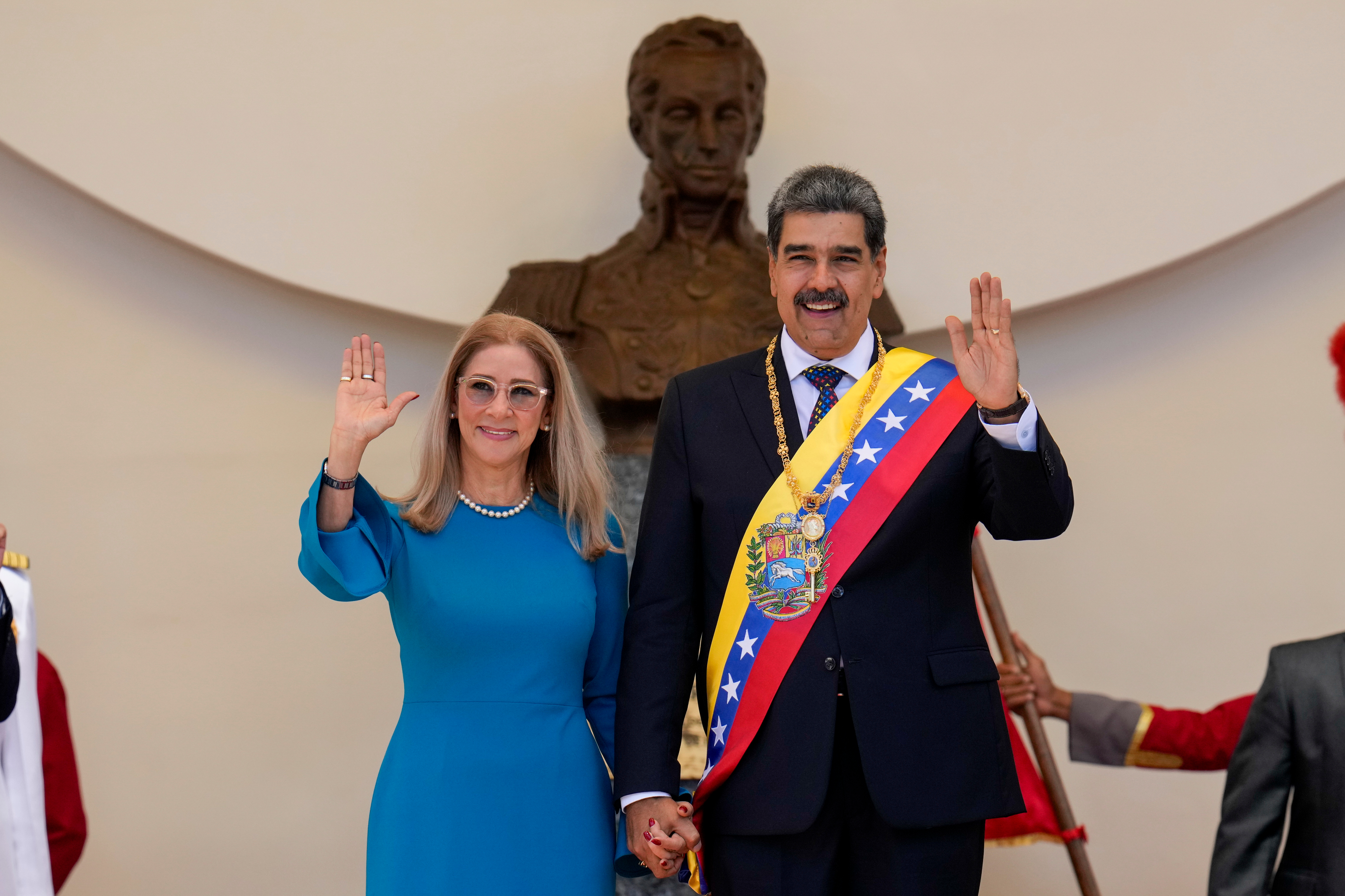 FILE - Venezuelan President Nicolas Maduro and his wife Cilia Flores wave after his swearing-in ceremony for a third term at the National Assembly in Caracas, Venezuela, on Jan. 10, 2025. (AP Photo/Ariana Cubillos, File)