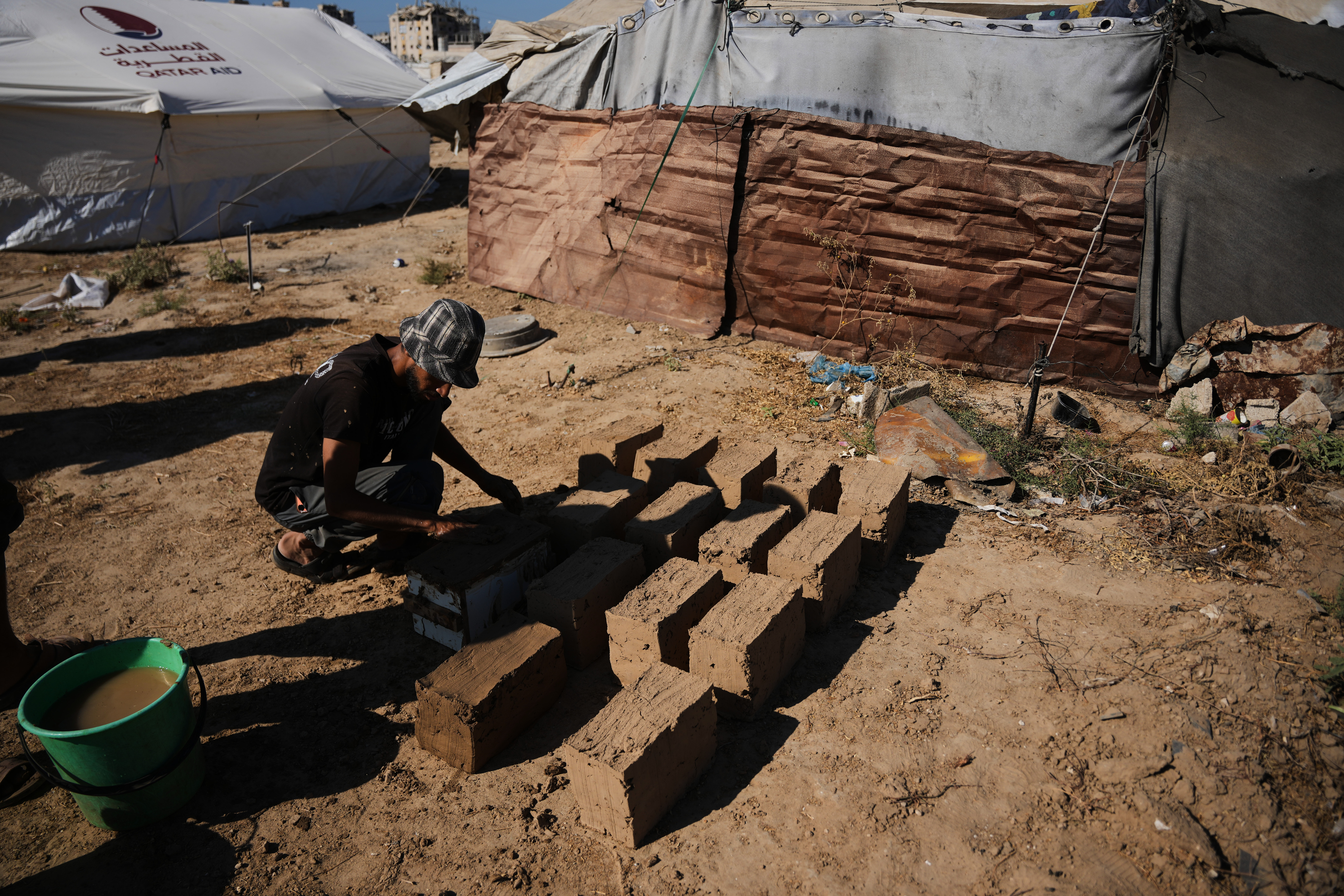 Palestinians rebuild Gaza’s ruins with mud bricks and scrap