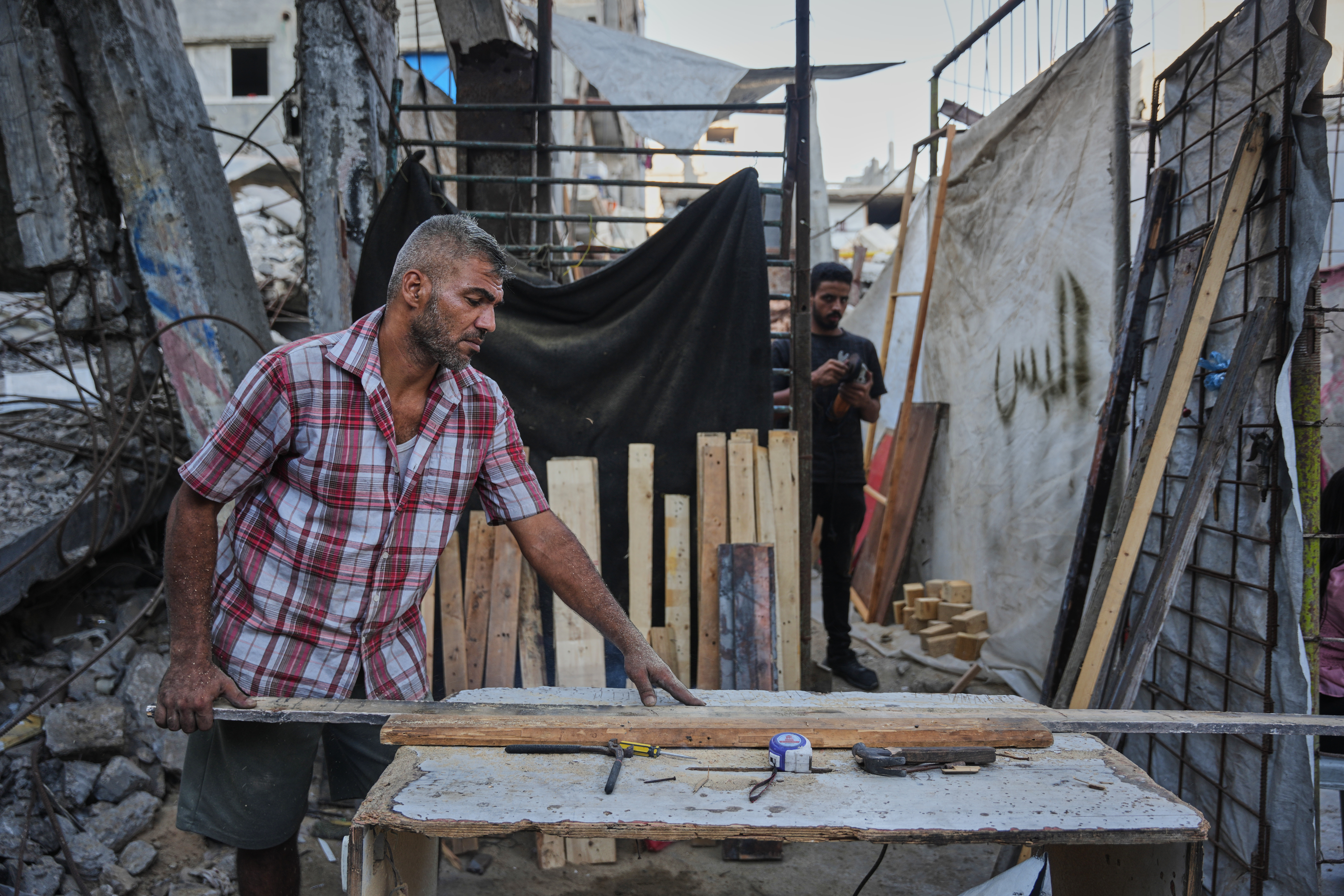 Palestinians rebuild Gaza’s ruins with mud bricks and scrap